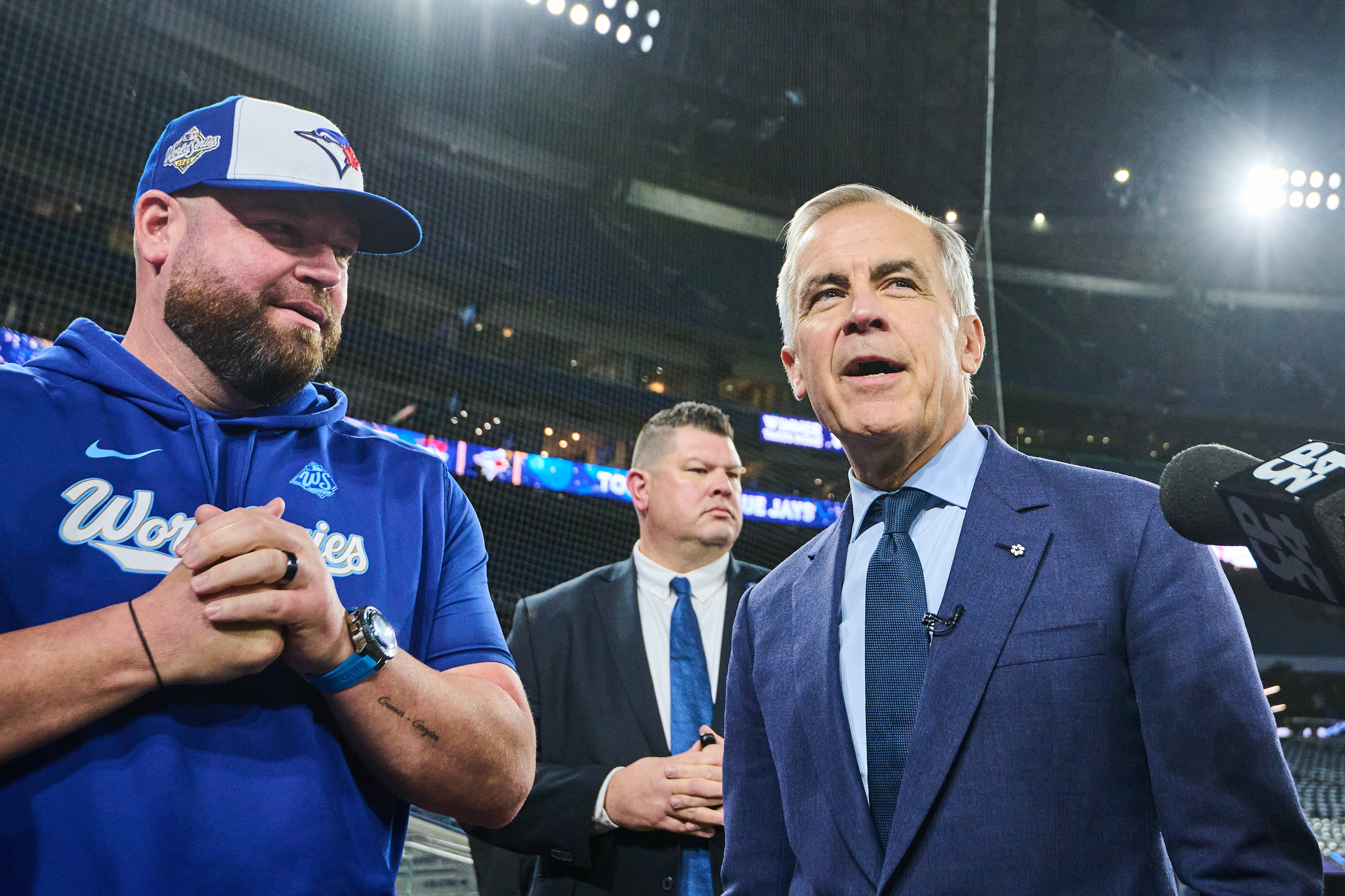 Canada's Prime Minister Mark Carney speaks to Toronto Blue Jays manager John Schneider as he visits the Blue Jays during baseball's World Series media day, Thursday, Oct. 23, 2025, in Toronto,.