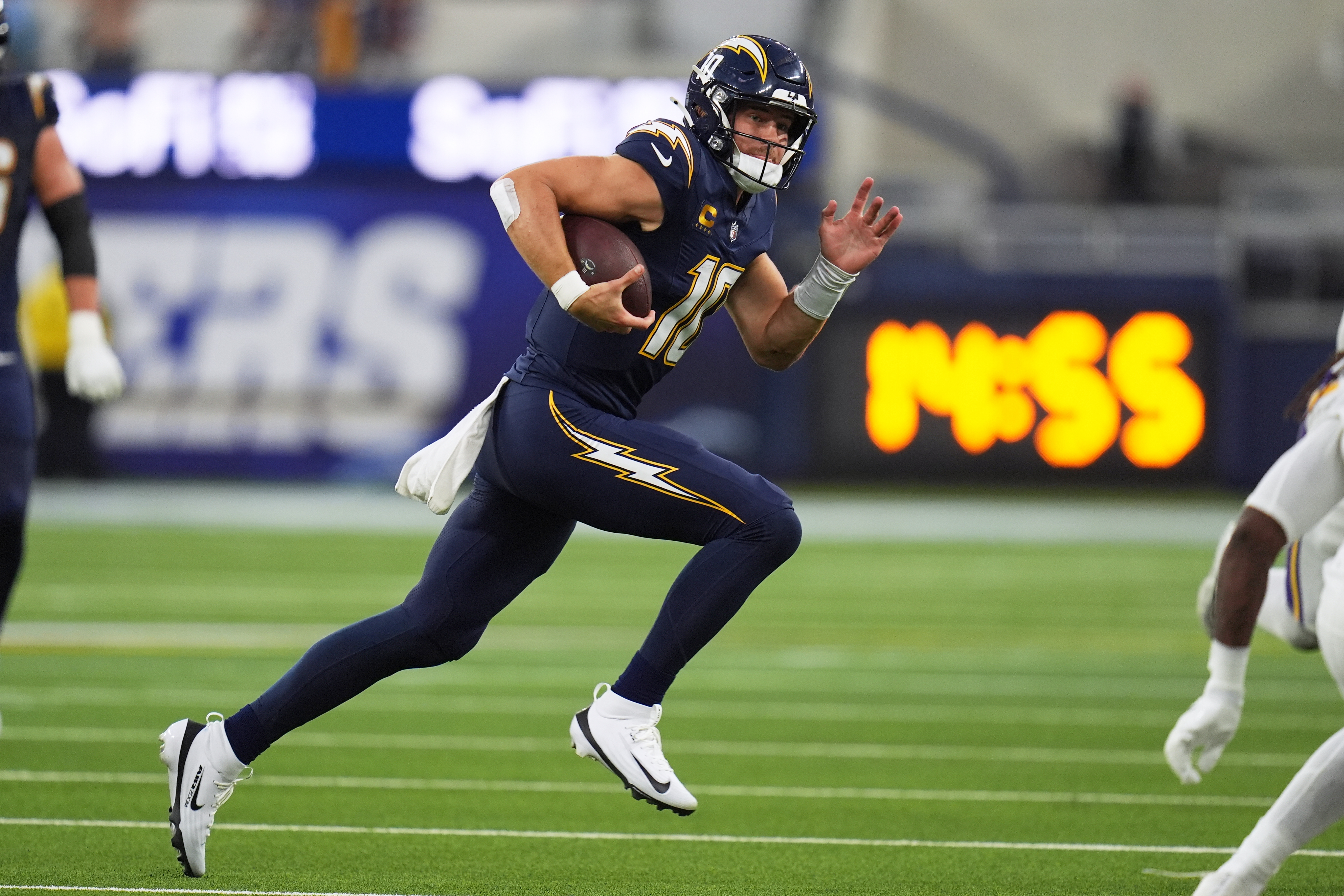 Los Angeles Chargers quarterback Justin Herbert (10) runs with the football during the first half of an NFL football game against the Minnesota Vikings Thursday, Oct. 23, 2025, in Inglewood, Calif. 