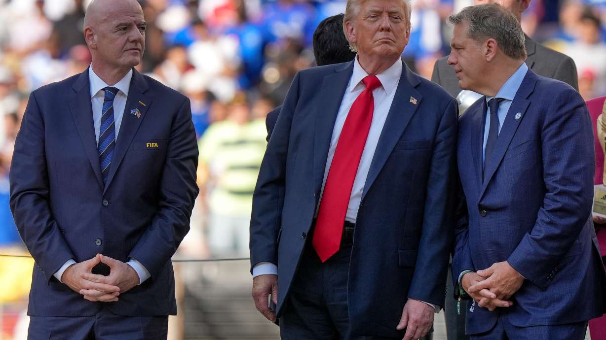 FILE - President Donald Trump, center, talks with Chelsea football club owner Todd Boehly, right, as FIFA president Gianni Infantino, left, looks on before the trophy ceremony of the Club World Cup final soccer match in East Rutherford, N.J., Sunday, July 13, 2025.