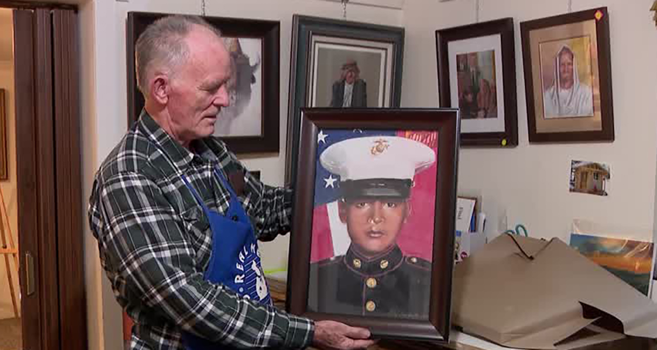 Artist J.R. Johansen holds a portrait of U.S. Marine David Espinoza, who died in Afghanistan, at Johansen's studio in Huntsville on Thursday. The portrait is for Espinoza's family.
