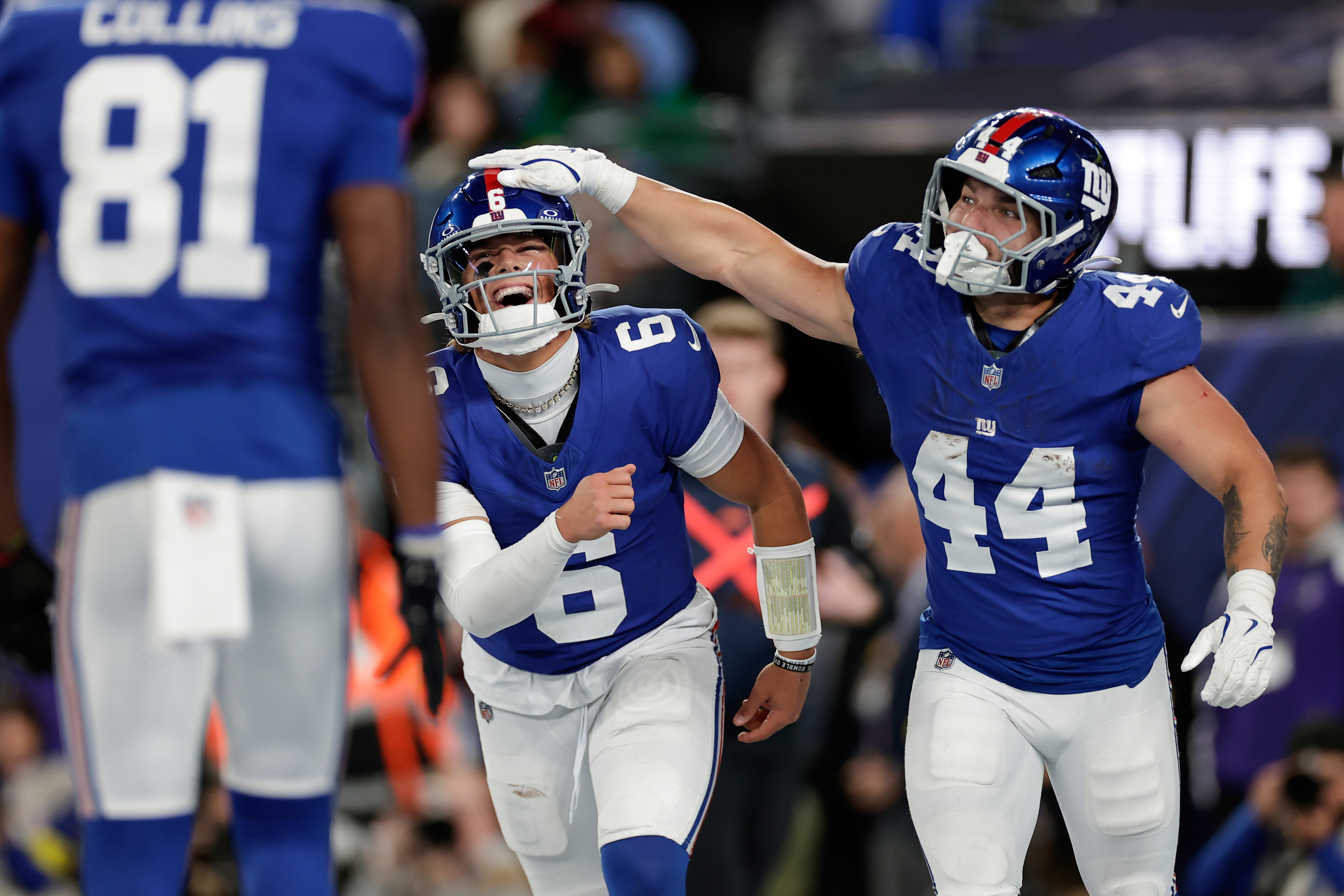 New York Giants' Jaxson Dart, center, and Cam Skattebo celebrate after a touchdown during the first half of an NFL football game against the Philadelphia Eagles Thursday, Oct. 9, 2025, in East Rutherford, N.J. 