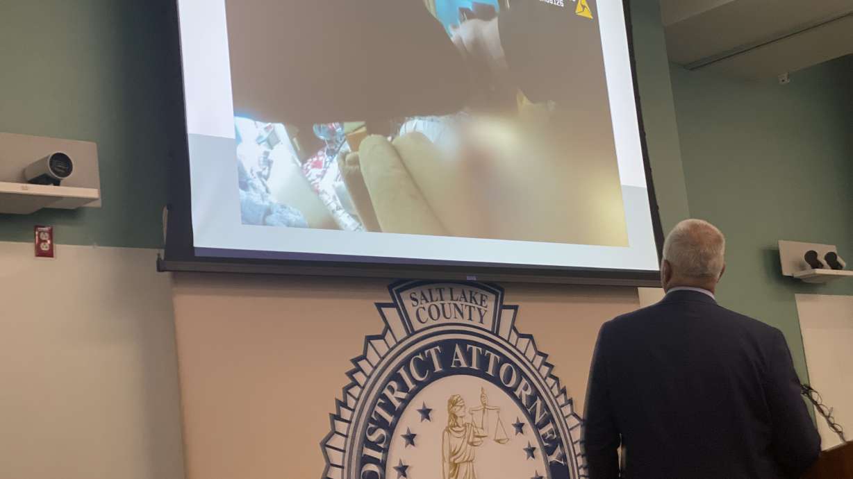 Salt Lake County District Attorney Sim Gill shows video Friday from the shooting death of a man caught in the act of stabbing his parents to death. Gill says it highlights a bigger issue of how people experiencing mental illness need to get help.