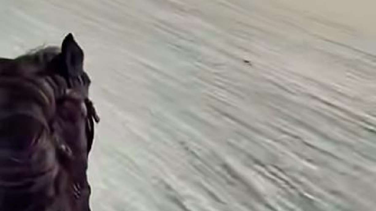 A rider crosses the desert in high winds and sandstorms on Dec. 12, 2023, in Tacheng, Xinjiang, China.