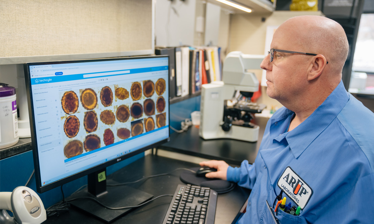 Blaine Mathison, ARUP's technical director of parasitology and adjunct lecturer in the University of Utah's Department of Pathology, reviews digital images of wet-mount slides.