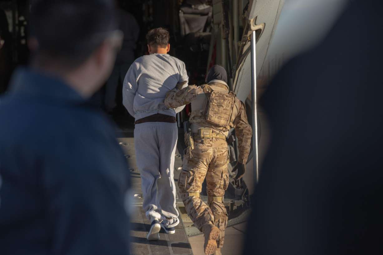 A man is led onto a deportation flight at Biggs Army Airfield, in Fort Bliss, Texas, Feb. 8. The detention facility at Fort Bliss allegedly has violated dozens of federal standards.