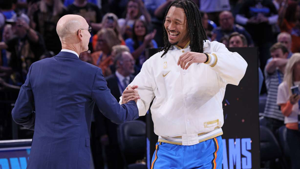 Oklahoma City Thunder forward Jaylin Williams, right, greets NBA commissioner Adam Silver during the championship ring ceremony before an NBA basketball game against the Houston Rockets, Tuesday, Oct. 21, 2025, in Oklahoma City.