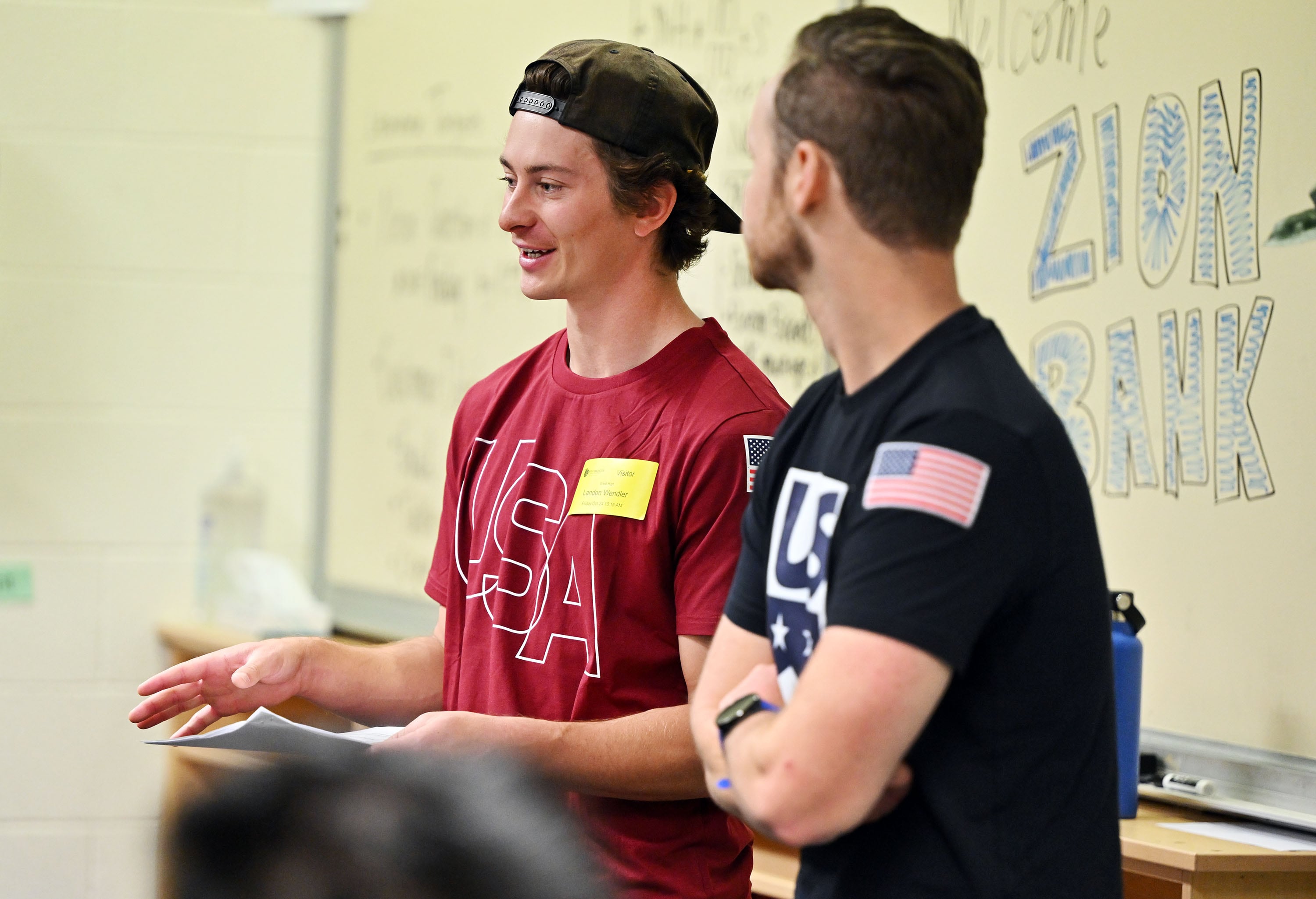 Olympic athletes Landon Wendler and Andrew Haraghey visit students at West High School to discuss the practice of financial discipline being a key to avoiding snowballing debt in life, in Salt Lake City on Friday.