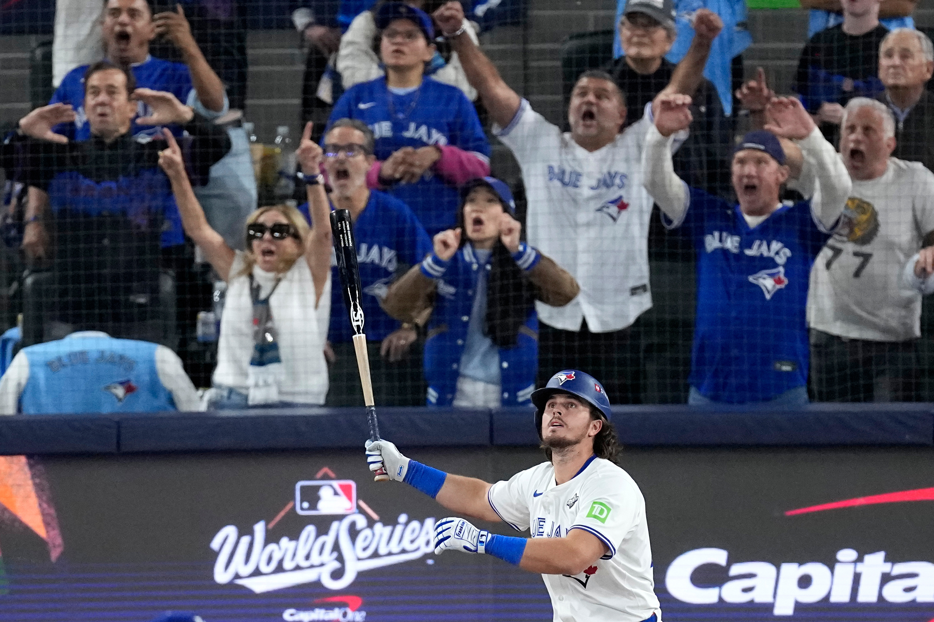 Toronto Blue Jays' Addison Barger watches his grand slam home run take flight as Los Angeles Dodgers' pitcher Anthony Banda, left, looks away uring the sixth inning in Game 1 of baseball's World Series, Friday, Oct. 24, 2025, in Toronto. 