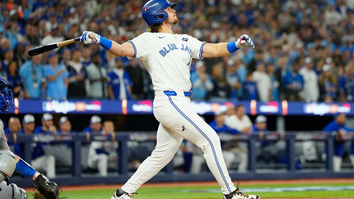 Toronto Blue Jays' Addison Barger watches his grand slam against the Los Angeles Dodgers during the sixth inning of Game 1 of baseball's World Series in Toronto, Friday, Oct. 24, 2025.