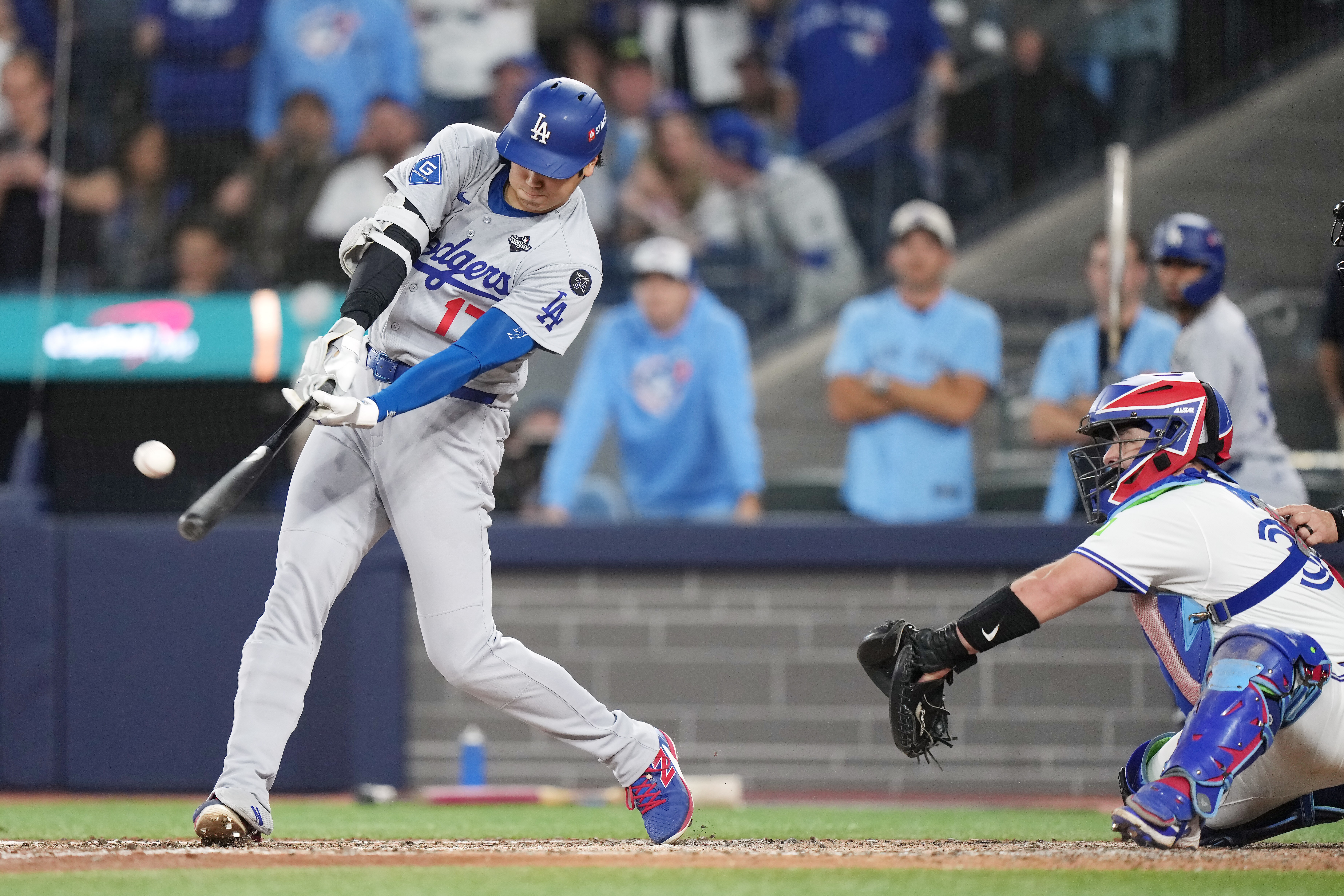 Los Angeles Dodgers' Shohei Ohtani (17) hits a two-run home run against the Toronto Blue Jays during the sixth inning in Game 1 of baseball's World Series, Friday, Oct. 24, 2025, in Toronto. 