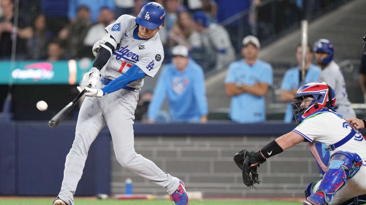 Los Angeles Dodgers' Shohei Ohtani (17) hits a two-run home run against the Toronto Blue Jays during the sixth inning in Game 1 of baseball's World Series, Friday, Oct. 24, 2025, in Toronto.