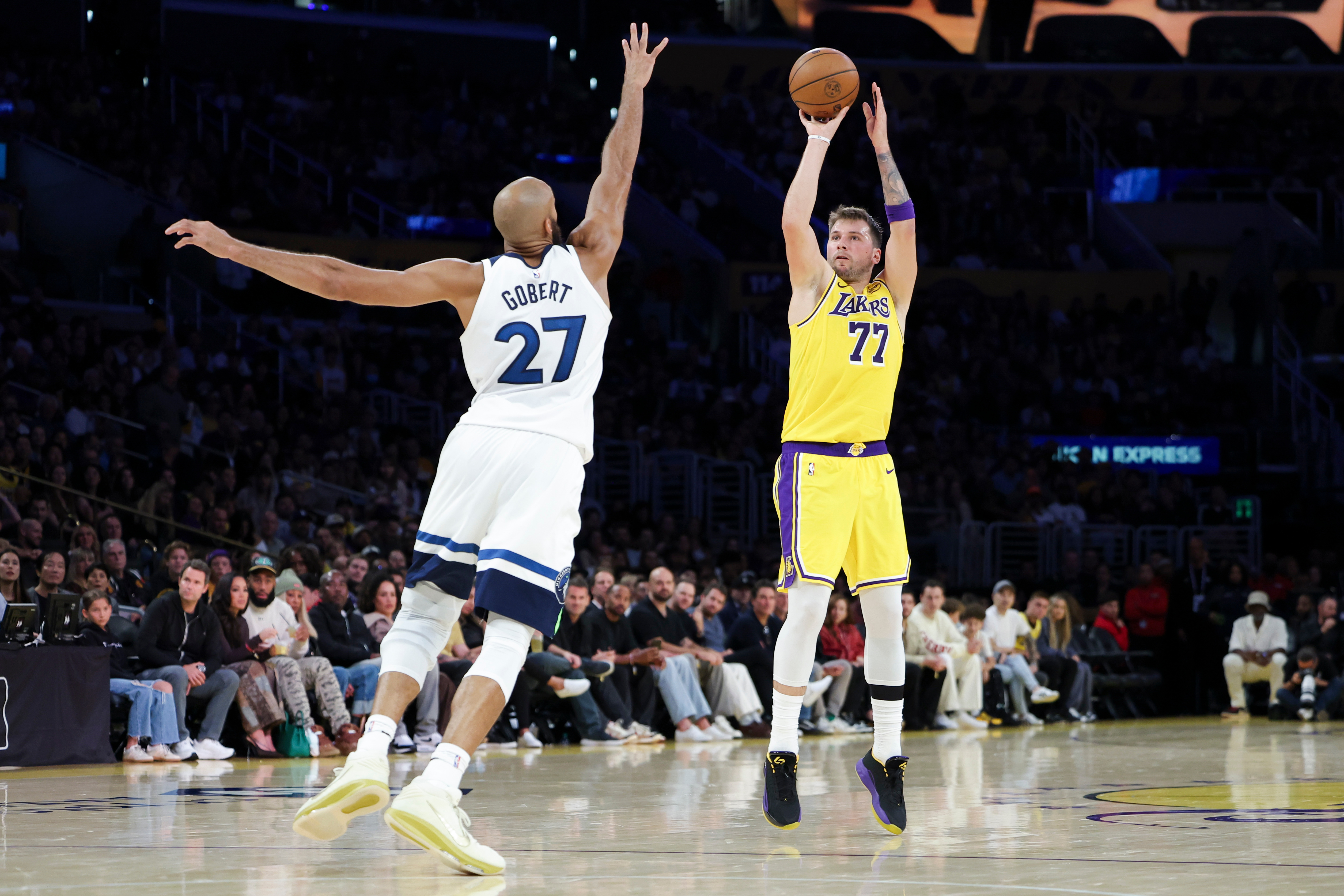 Los Angeles Lakers guard Luka Doncic (77) shoots against the Minnesota Timberwolves center Rudy Gobert (27) during the first half of an NBA basketball game, Friday, Oct. 24, 2025, in Los Angeles.