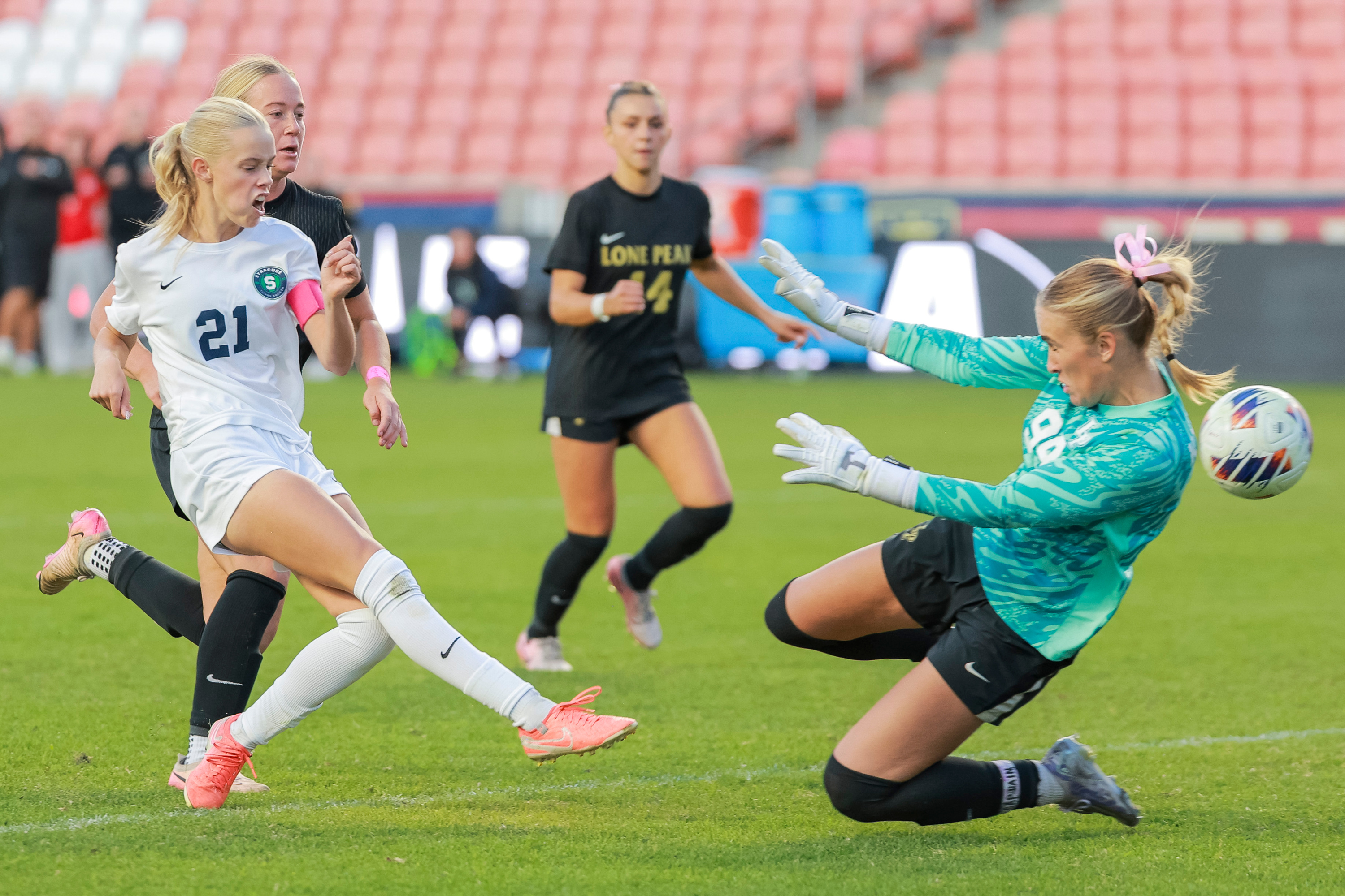 Syracuse’s Taylee Hughes (21) shoots the ball past Lone Peak goalkeeper Eliza Collings (99) to score the go-ahead goal during the second half of the girls 6A soccer state championship game at America First Field in Sandy on Friday, Oct. 24, 2025. Syracuse won 2-0.