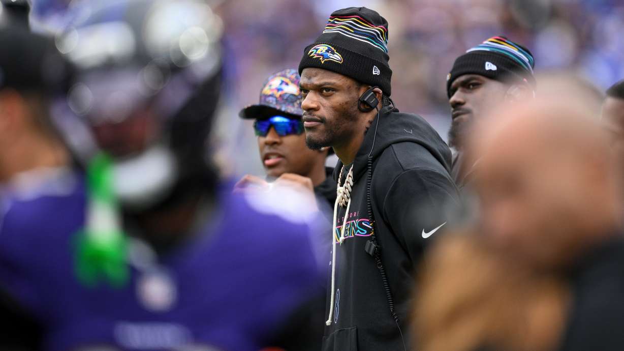 Baltimore Ravens quarterback Lamar Jackson looks on from the sidelines during the first half of an NFL football game against the Los Angeles Rams Sunday, Oct. 12, 2025, in Baltimore.