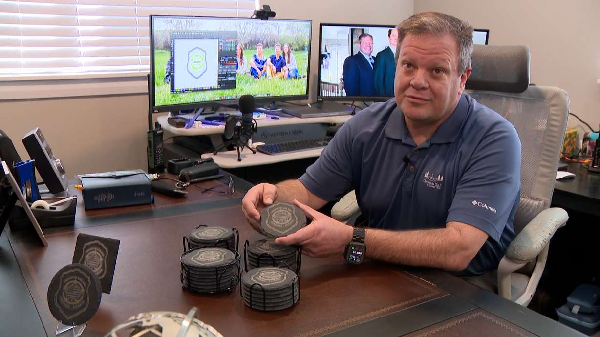 Darren Jex holds one of his laser-etched coasters at his home in Willard, Box Elder County. They're part of fundraising efforts to get Tremonton-Garland police officers to Washington, D.C., for National Police Week in May.