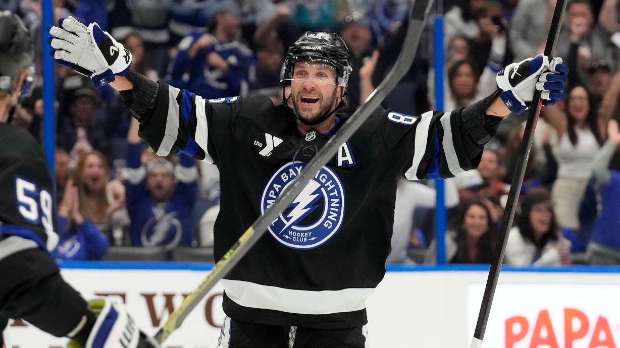 Tampa Bay Lightning right wing Nikita Kucherov (86) celebrates after picking up assist for his 1,000th career point on a goal by center Brayden Point during the second period of an NHL hockey game against the Anaheim Ducks Saturday, Oct. 25, 2025, in Tampa, Fla.
