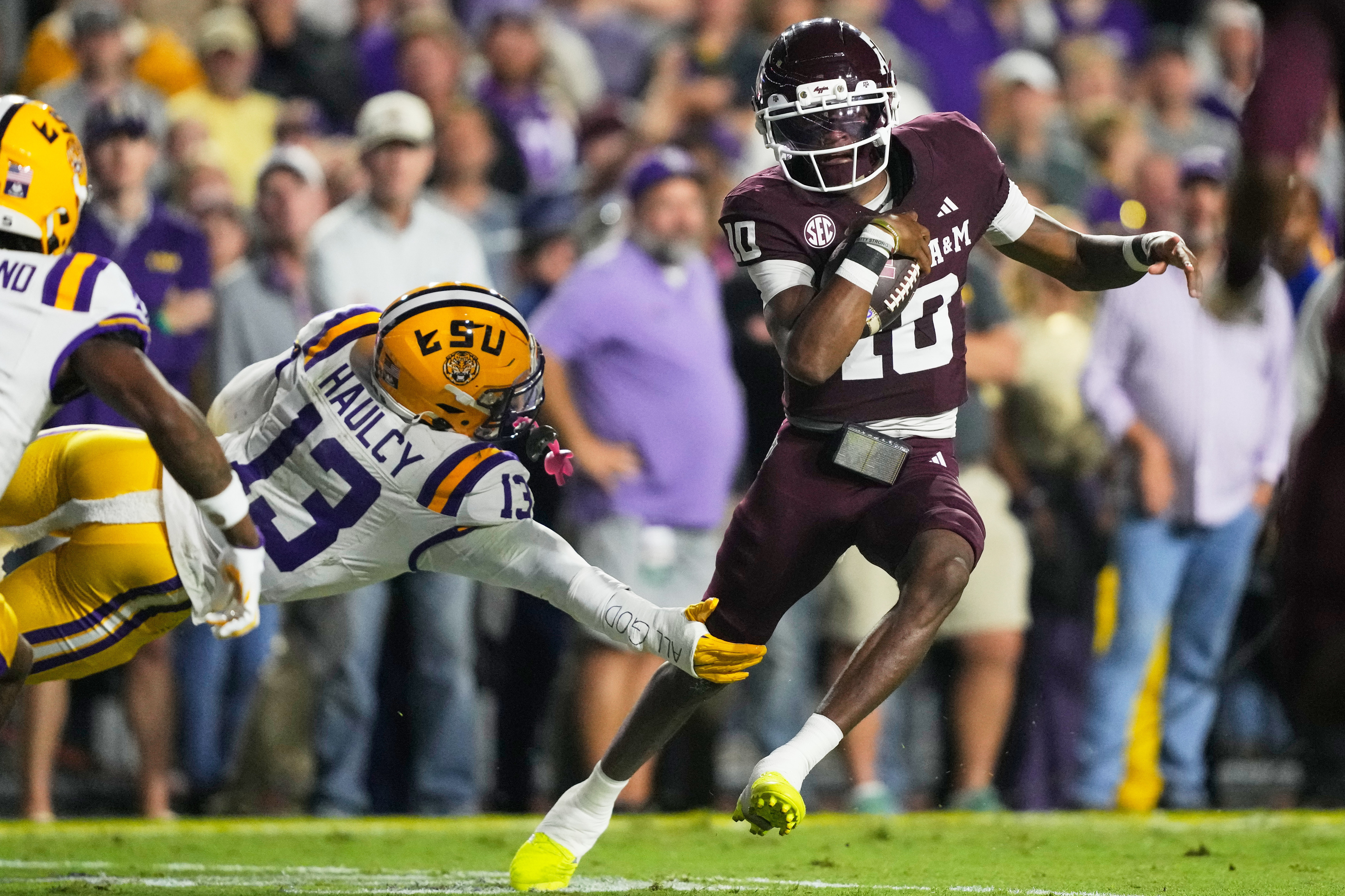 Texas A&M quarterback Marcel Reed (10) carries for a touchdown against LSU defensive back A.J. Haulcy (13) in the first half of an NCAA college football game, Saturday, Oct. 25, 2025 in Baton Rouge, La.