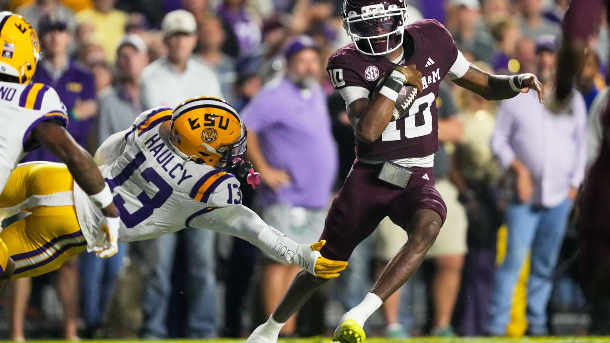 Texas A&M quarterback Marcel Reed (10) carries for a touchdown against LSU defensive back A.J. Haulcy (13) in the first half of an NCAA college football game, Saturday, Oct. 25, 2025 in Baton Rouge, La.