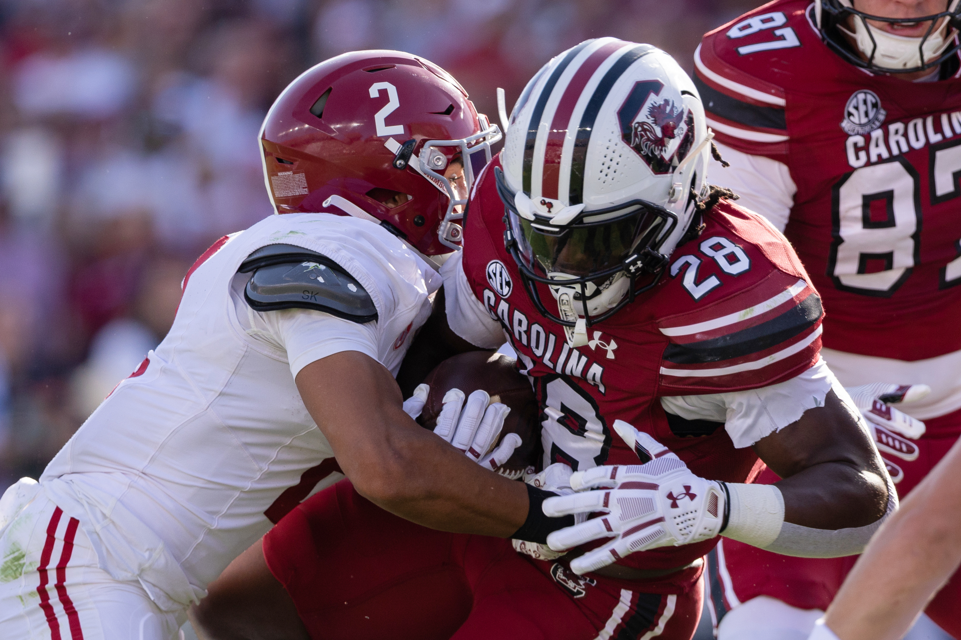 Alabama defensive back Zabien Brown (2) tackles South Carolina running back Matt Fuller (28) during the first half of an NCAA college football game, Saturday, Oct. 25, 2025, in Columbia, S.C.