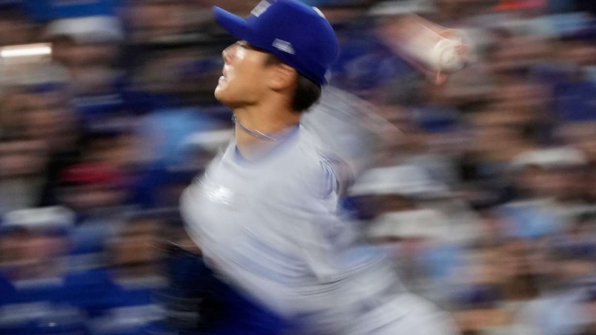 Los Angeles Dodgers pitcher Yoshinobu Yamamoto throws against the Toronto Blue Jays during the second inning in Game 2 of baseball's World Series, Saturday, Oct. 25, 2025, in Toronto.