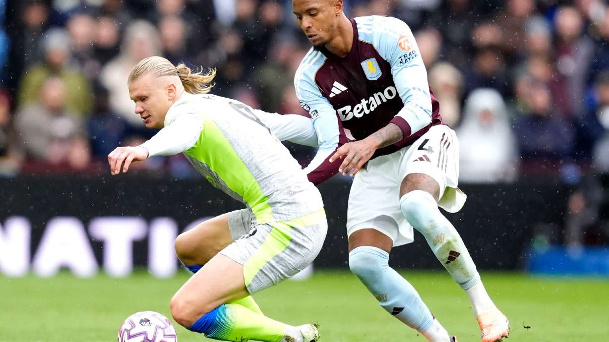 Manchester City's Erling Haaland (left) and Aston Villa's Ezri Konsa battle for the ball during the English Premier League match between Aston Villa and Manchester City, in Birmingham, England, Sunday Oct. 26, 2025.