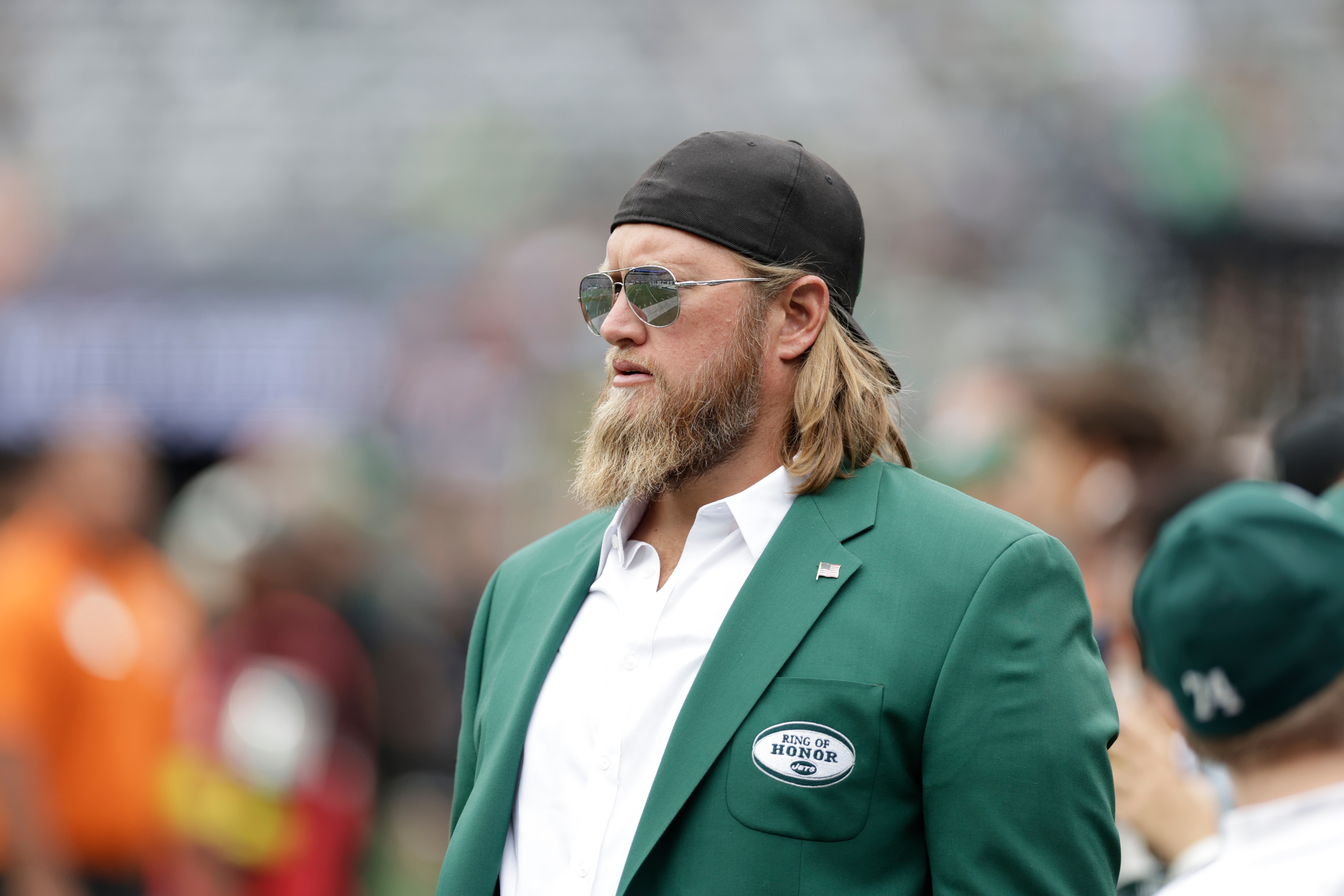 FILE - Former New York Jets player Nick Mangold walks the field before an NFL football game against the Cincinnati Bengals, Sept. 25, 2022, in East Rutherford, N.J. 