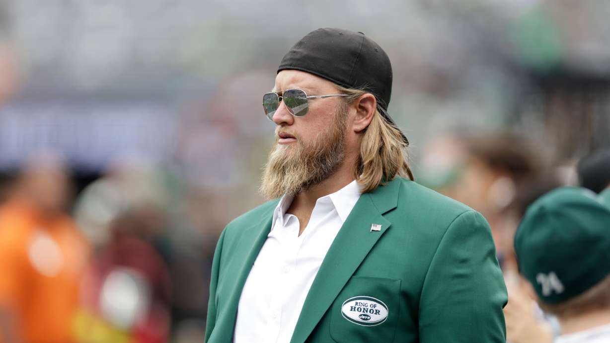 FILE - Former New York Jets player Nick Mangold walks the field before an NFL football game against the Cincinnati Bengals, Sept. 25, 2022, in East Rutherford, N.J.