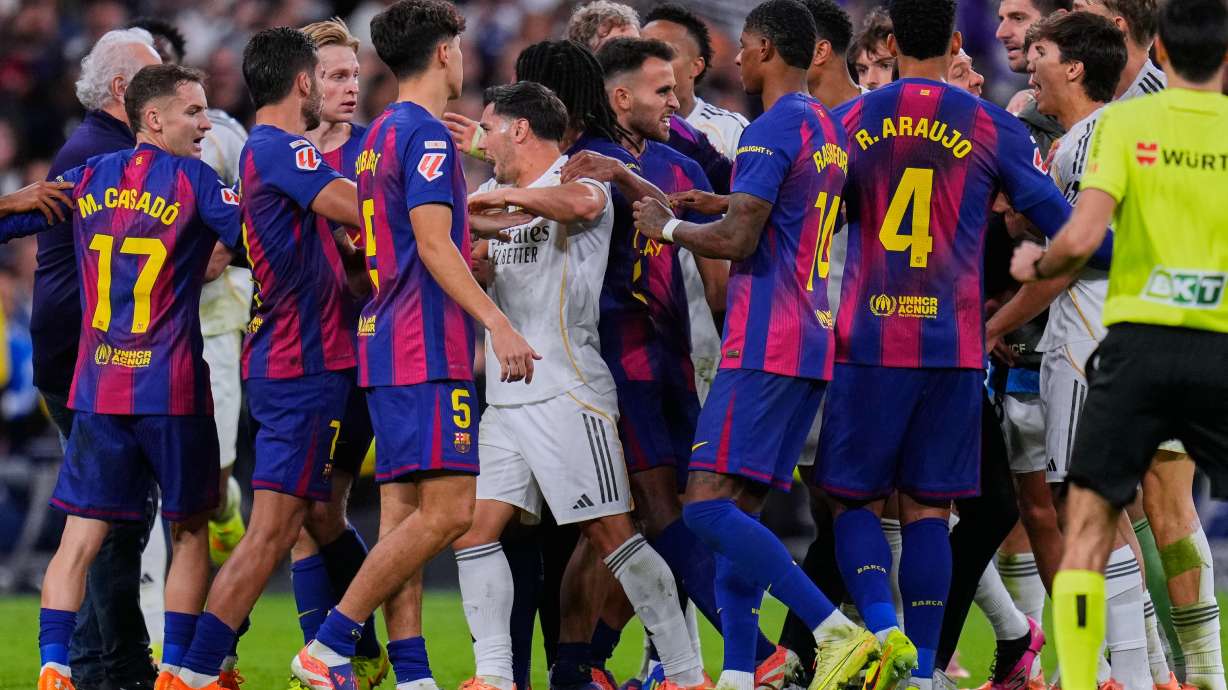 Real Madrid and Barcelona players scuffle during the Spanish La Liga soccer match between Real Madrid and Barcelona, in Madrid, Sunday, Oct. 26, 2025.