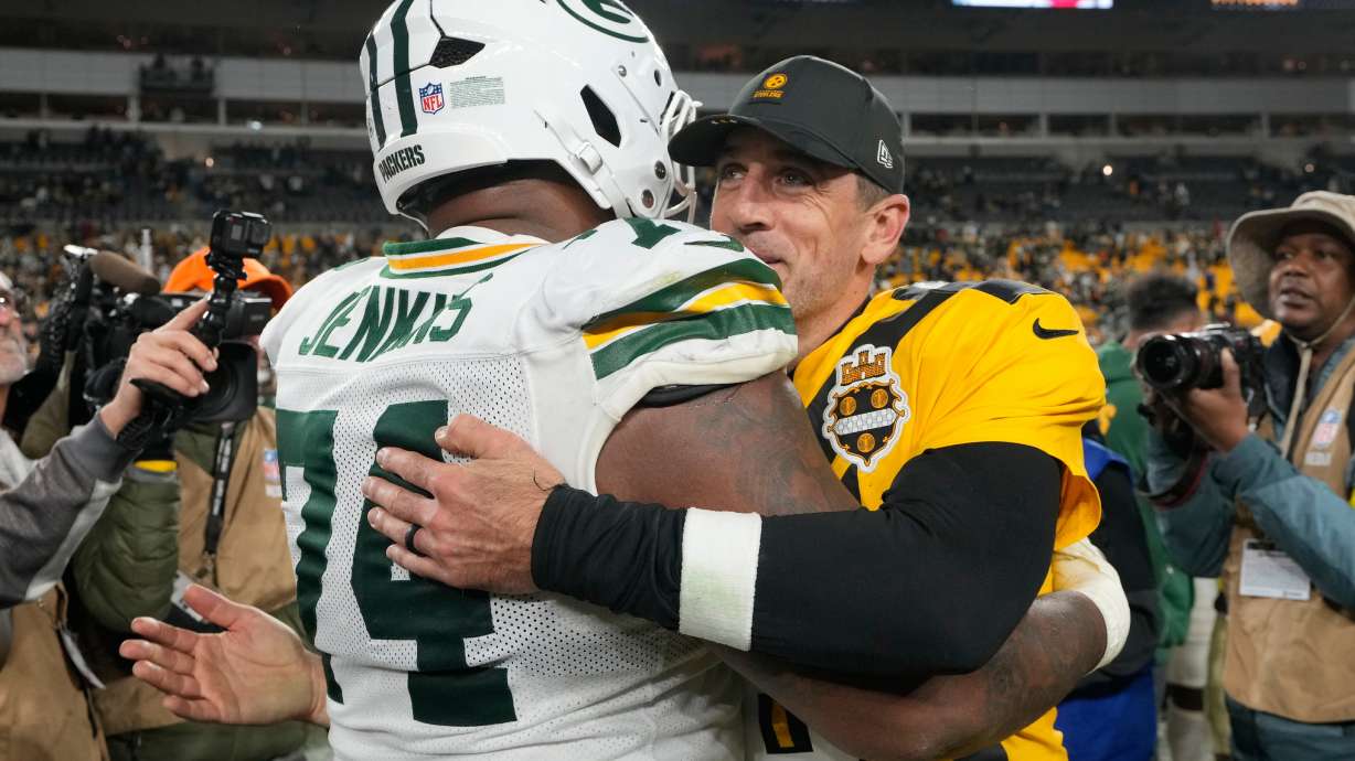 Pittsburgh Steelers' Aaron Rodgers hugs Green Bay Packers' Elgton Jenkins after an NFL football game Sunday, Oct. 26, 2025, in Pittsburgh.