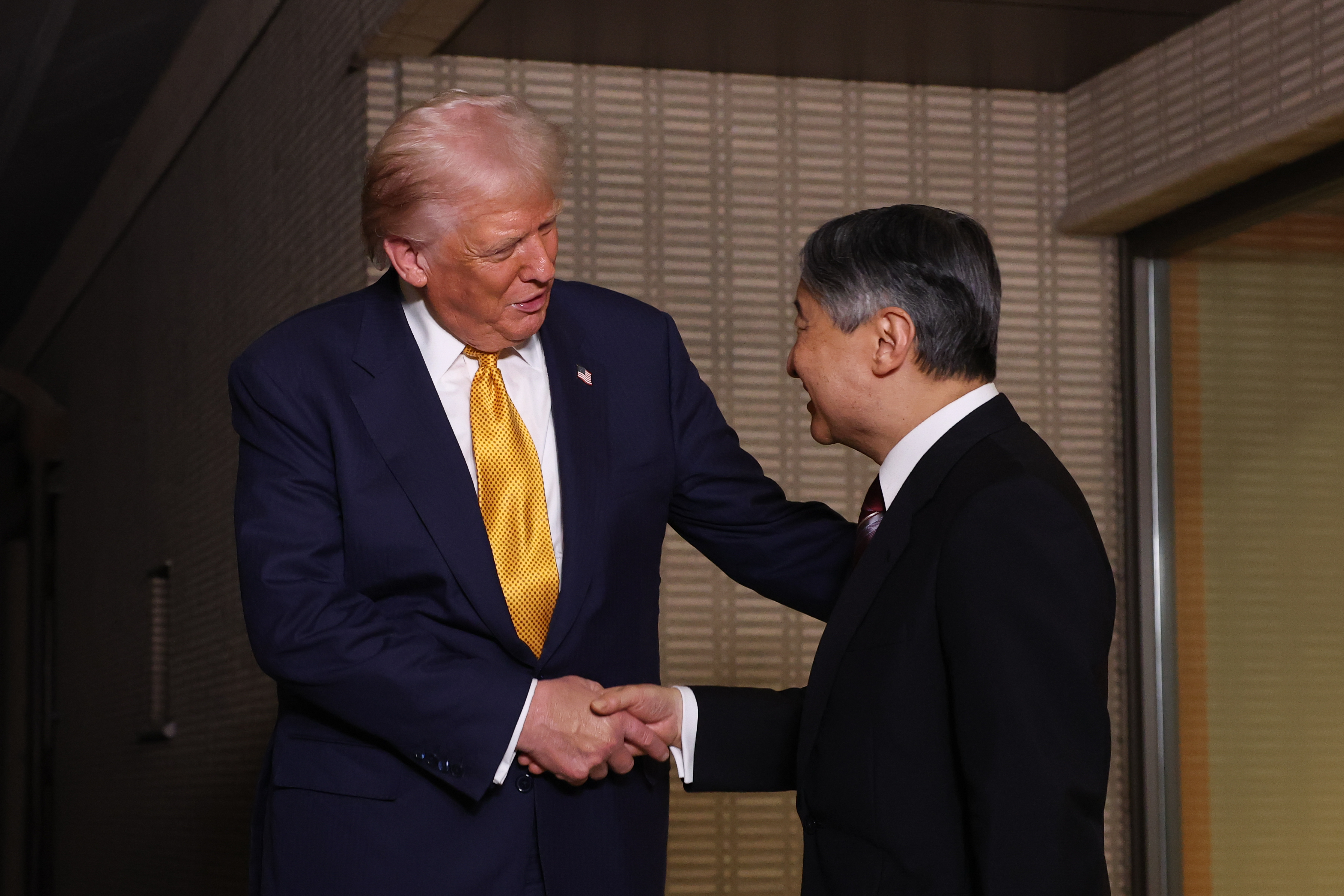 President Donald Trump, left, and Japan's Emperor Naruhito shake hands during their meeting at the Imperial Palace in Tokyo, Monday.