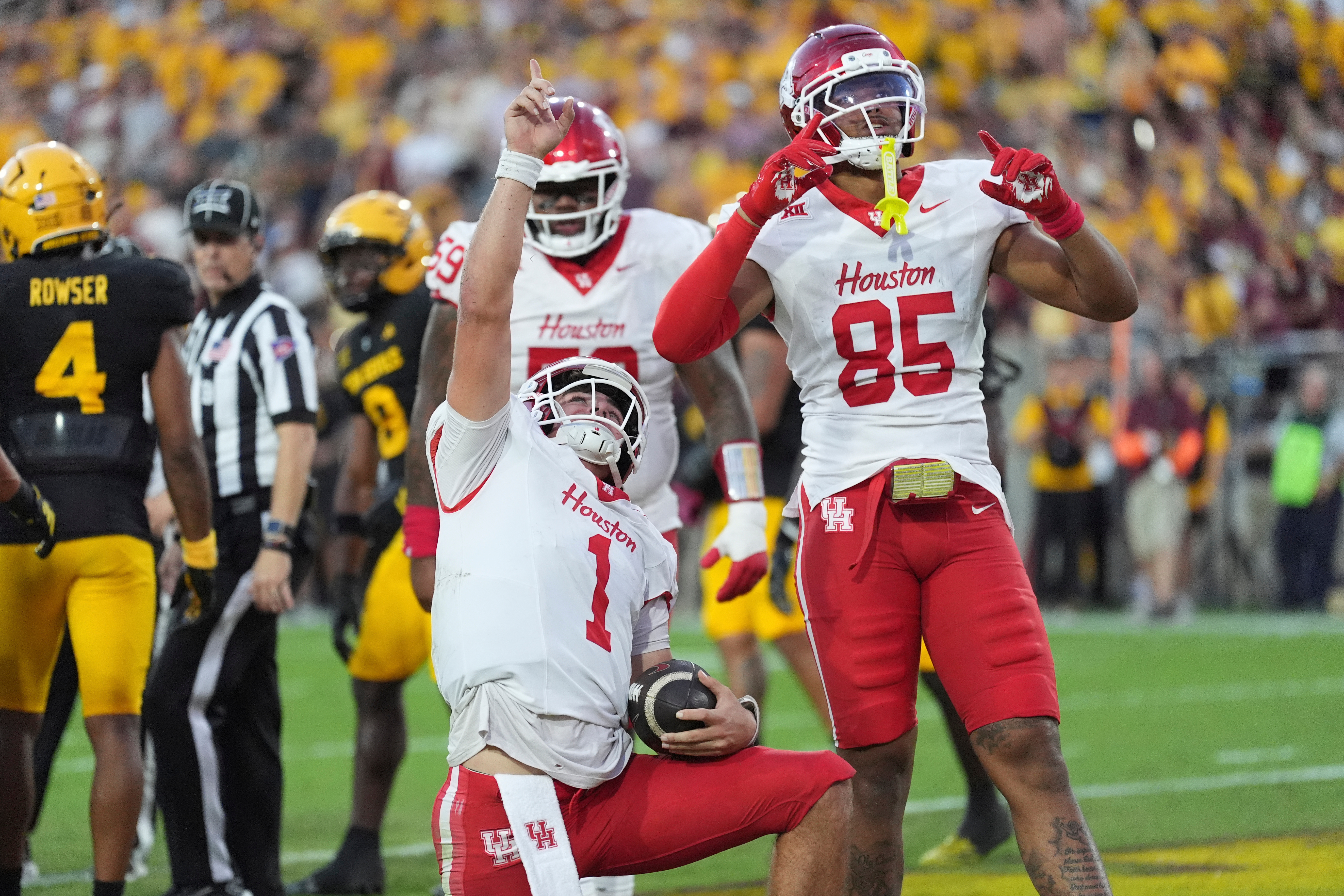 Houston quarterback Conner Weigman (1) celebrates his touchdown against Arizona State with Houston tight end Traville Frederick Jr. (85) during the first half of an NCAA college football game Saturday, Oct. 25, 2025, in Tempe, Ariz. 
