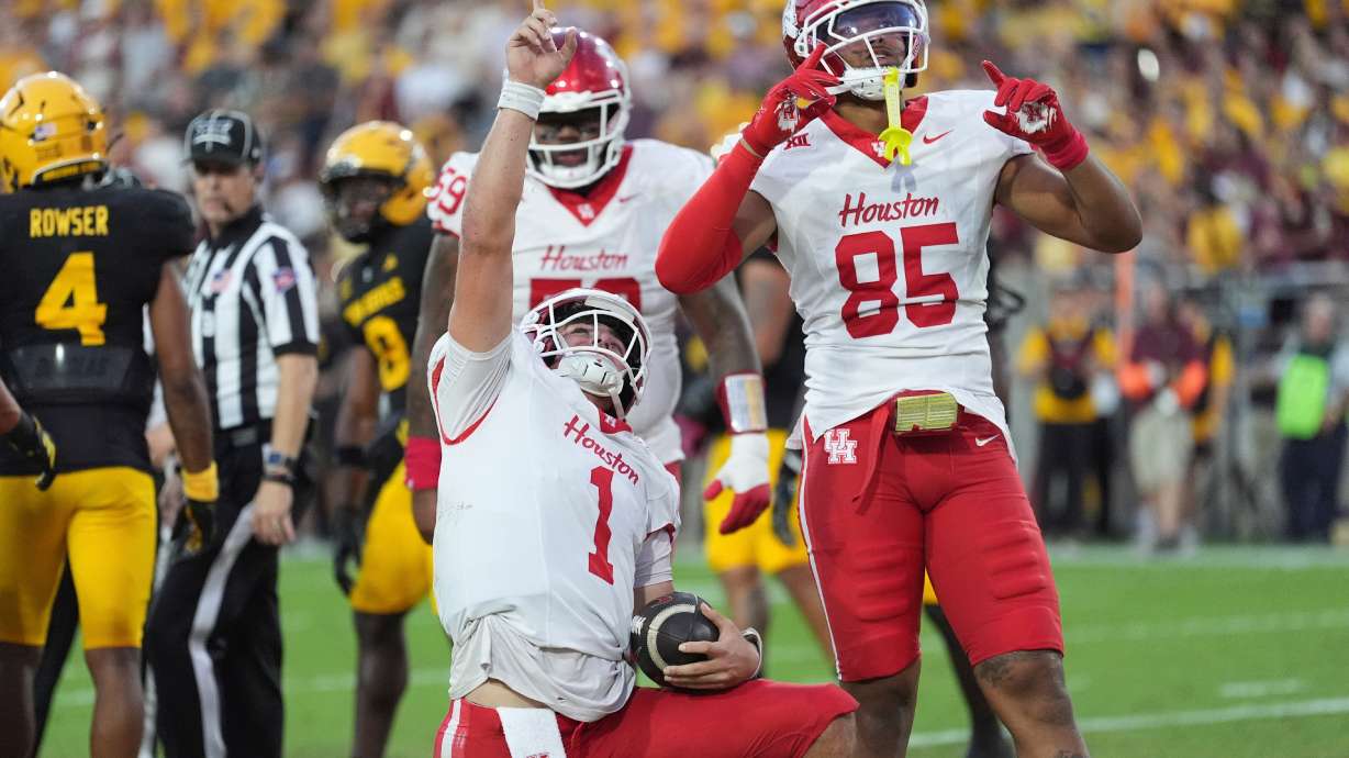 Houston quarterback Conner Weigman (1) celebrates his touchdown against Arizona State with Houston tight end Traville Frederick Jr. (85) during the first half of an NCAA college football game Saturday, Oct. 25, 2025, in Tempe, Ariz.