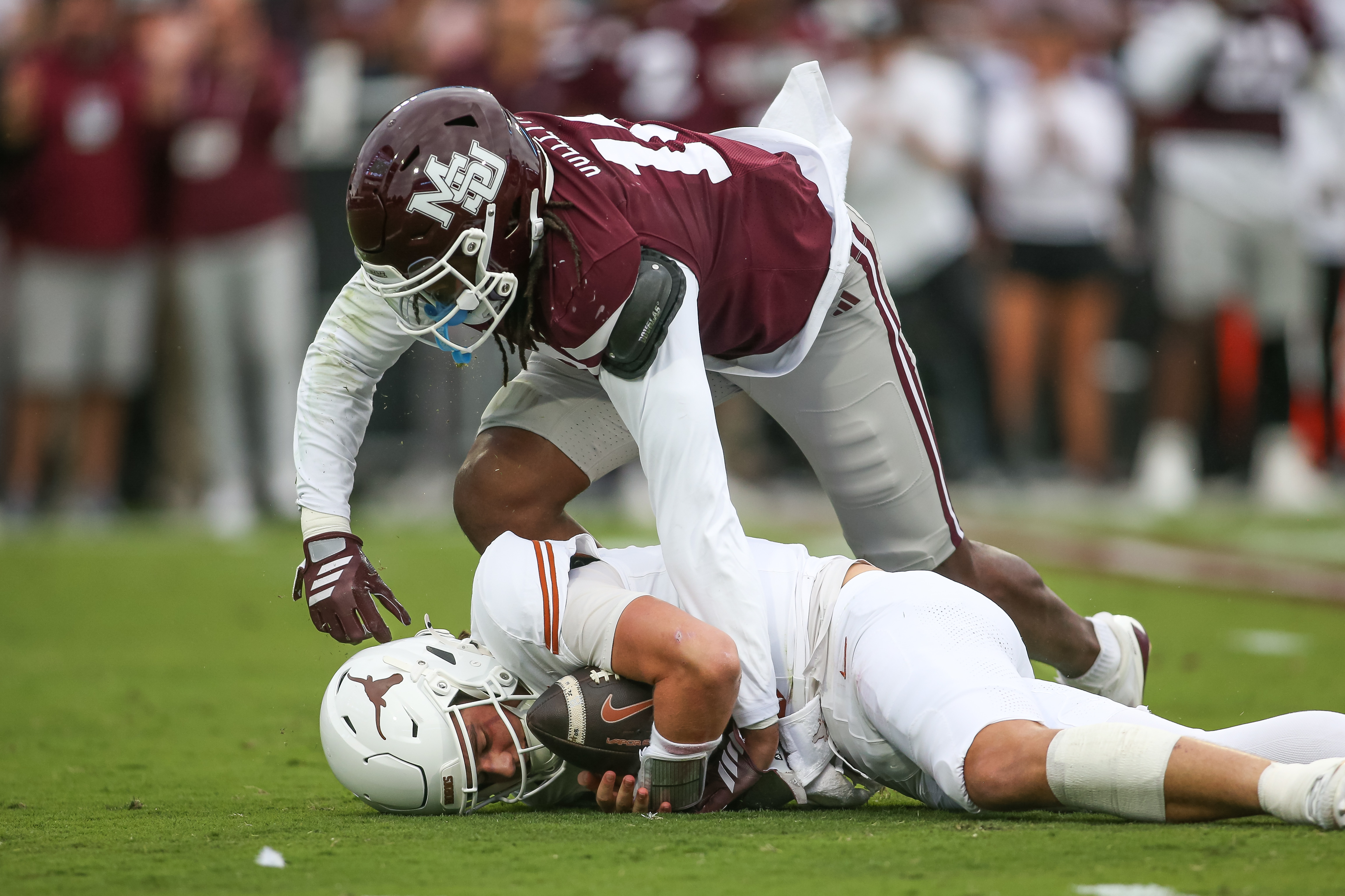 Mississippi State linebacker Derion Gullette, top, sacks Texas quarterback Arch Manning, bottom, during the first half of an NCAA college football game in Starkville, Miss., Saturday, Oct. 25, 2025. 