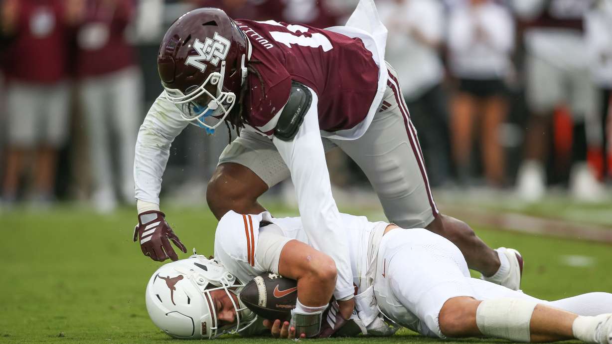 Mississippi State linebacker Derion Gullette, top, sacks Texas quarterback Arch Manning, bottom, during the first half of an NCAA college football game in Starkville, Miss., Saturday, Oct. 25, 2025.