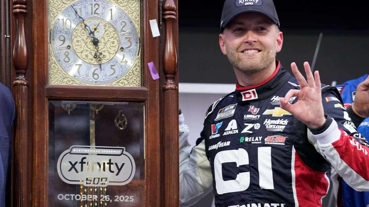William Byron poses with the trophy in Victory Lane after winning a NASCAR Cup series auto race in Martinsville, Va., Sunday, Oct. 26, 2025.