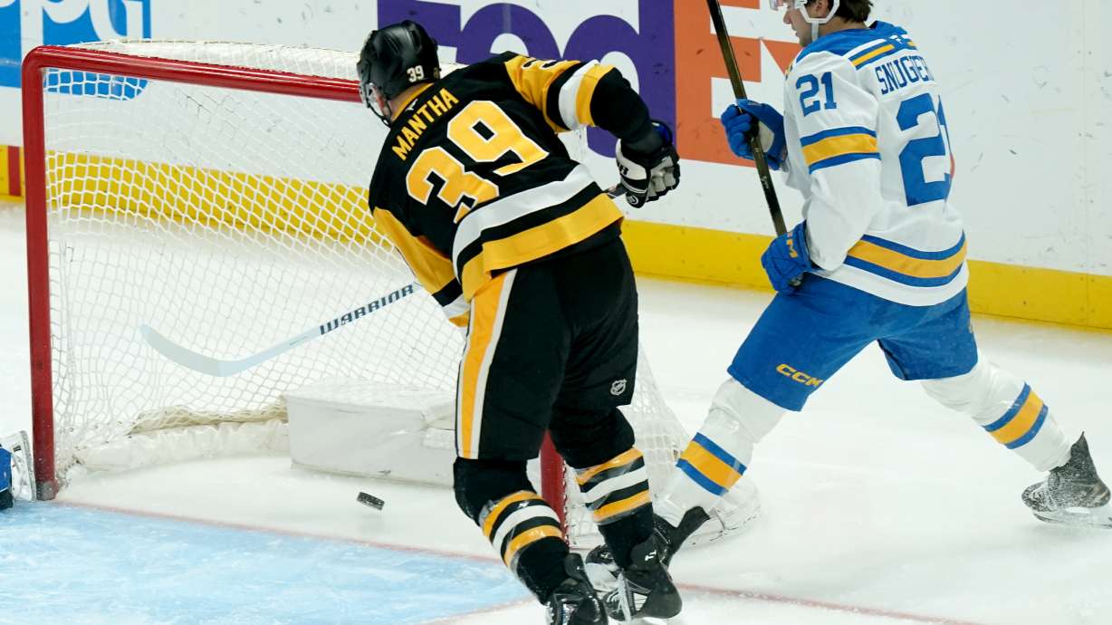 Pittsburgh Penguins' Anthony Mantha (39) scores next to St. Louis Blues' Jimmy Snuggerud (21) during the first period of an NHL hockey game, Monday, Oct. 27, 2025, in Pittsburgh.