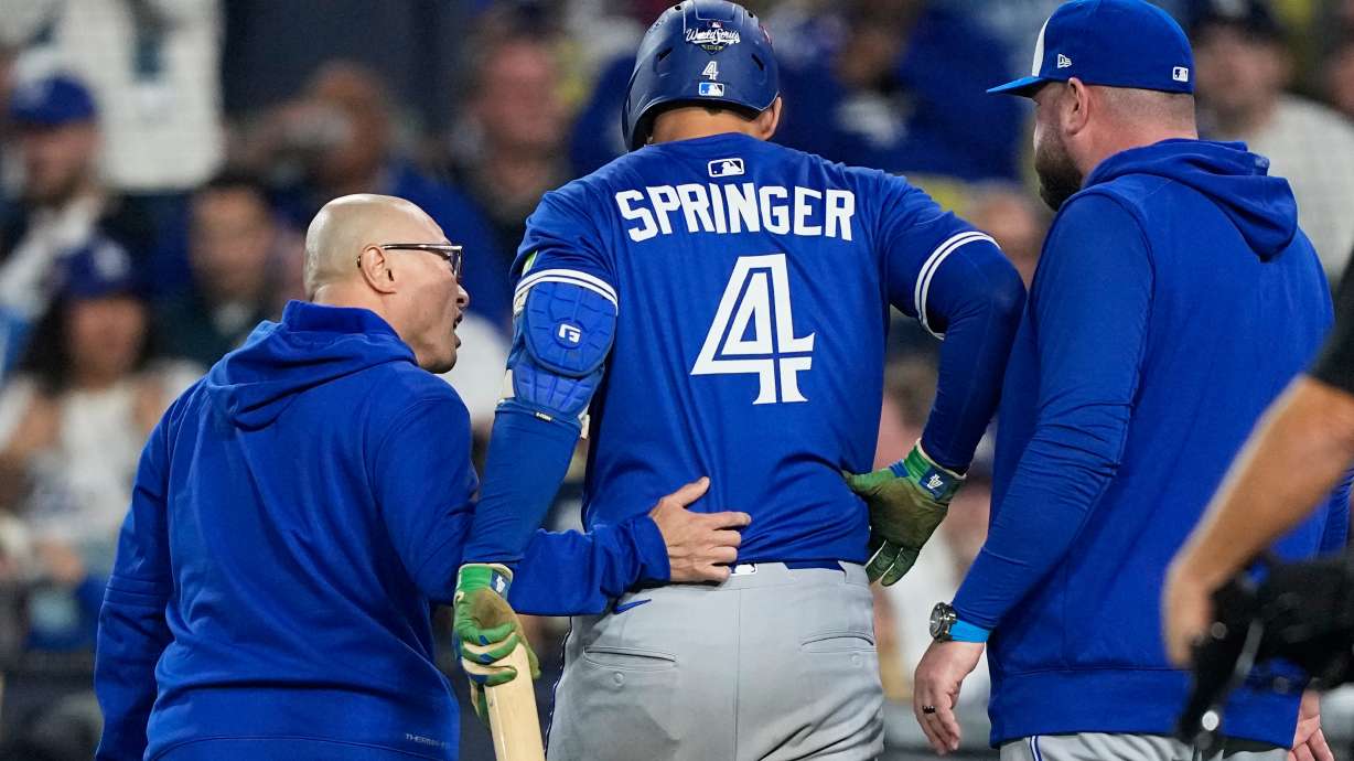 Toronto Blue Jays' George Springer leaves the game with an injury during the seventh inning in Game 3 of baseball's World Series against the Los Angeles Dodgers, Monday, Oct. 27, 2025, in Los Angeles.
