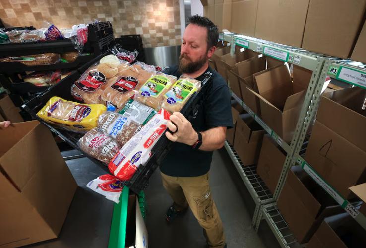 Clint Miller sorts bread while volunteering at the Utah Food Bank in South Salt Lake on Monday. The government shutdown could impact $33 million in Utah SNAP benefits.