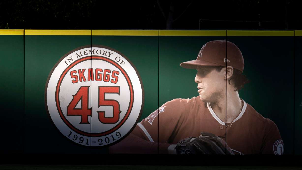 FILE - An image and logo memorializing former Los Angeles Angels pitcher Tyler Skaggs is displayed on the outfield wall in Anaheim, Calif., July 17, 2019.