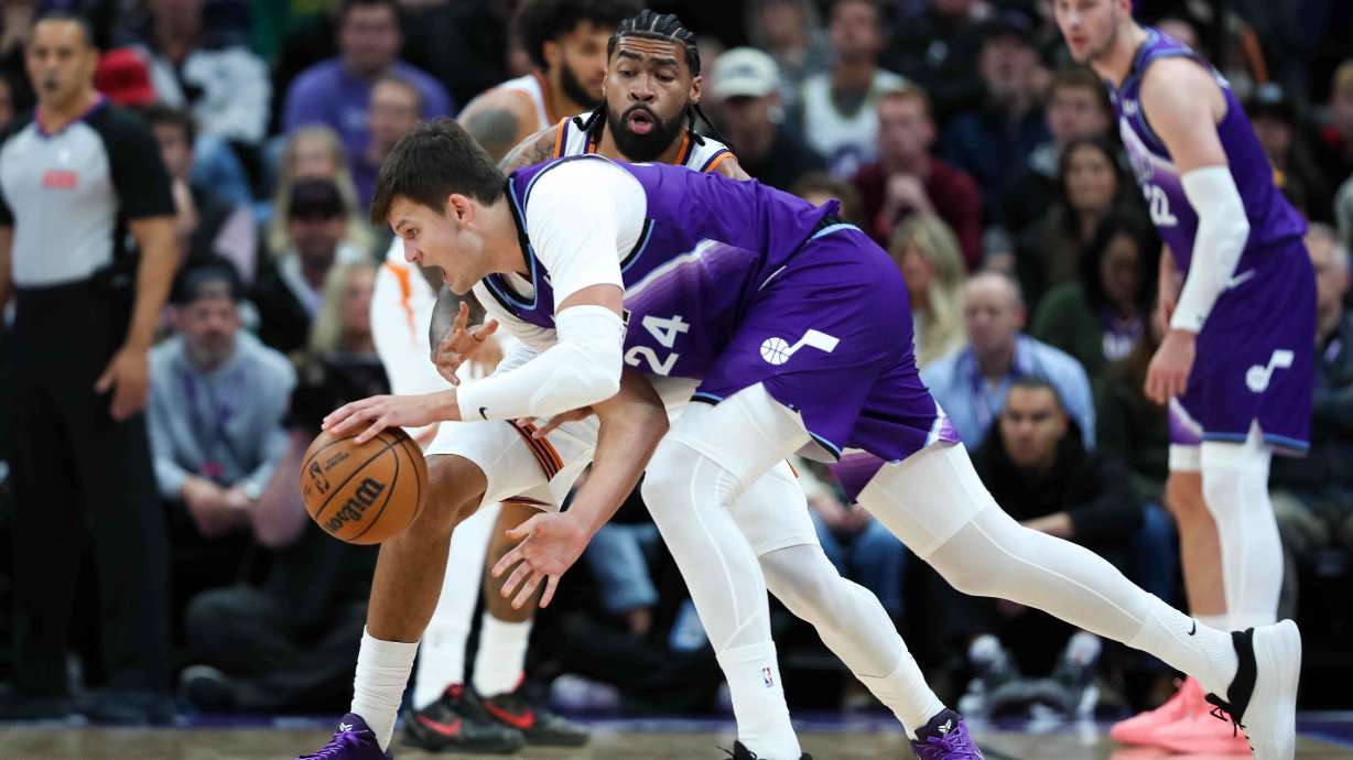 Phoenix Suns center Nick Richards, top, defends against Utah Jazz center Walker Kessler (24) during the first half of an NBA basketball game, Monday, Oct. 27, 2025, in Salt Lake City.