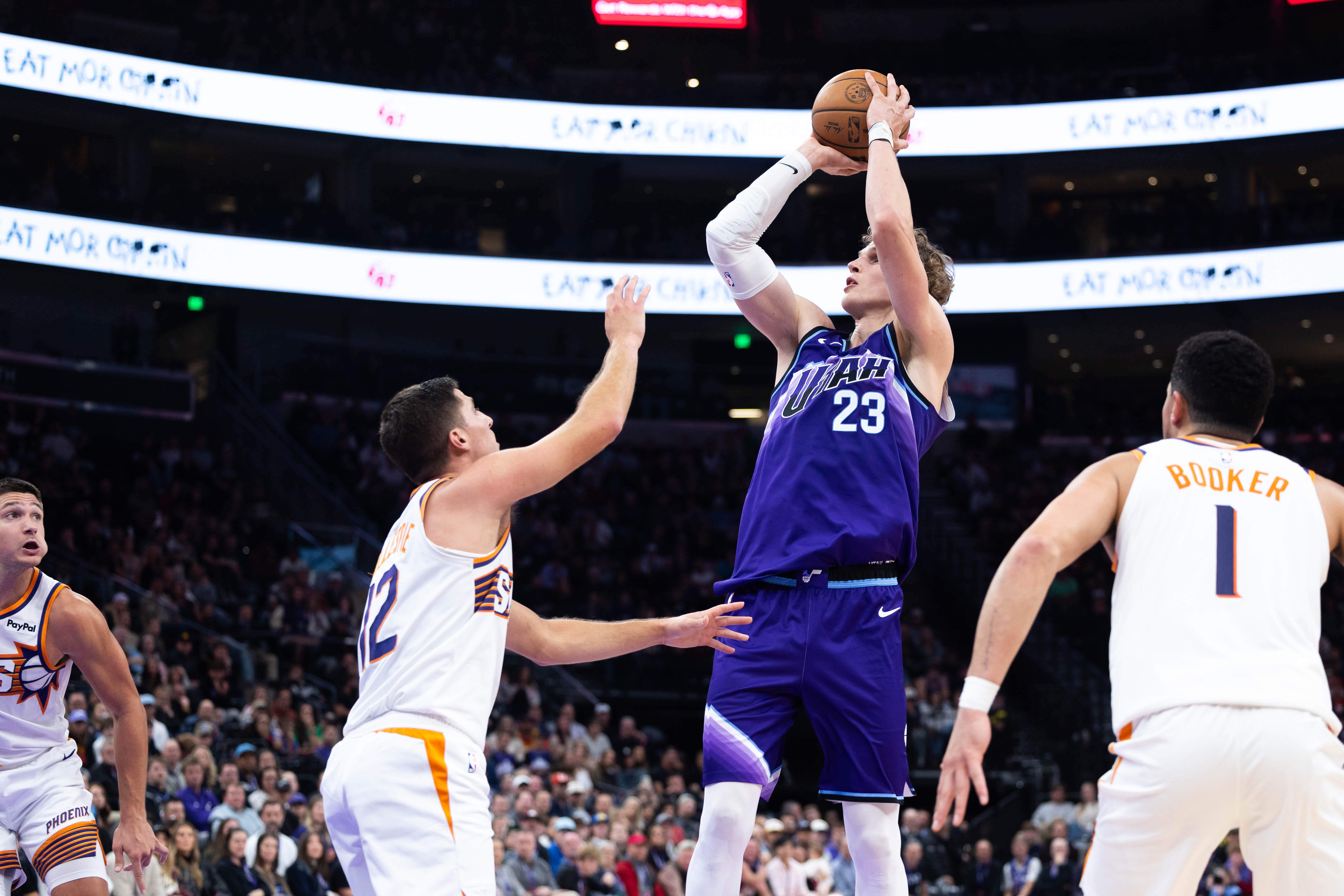 Utah Jazz forward Lauri Markkanen (23) shoots over Phoenix Suns guard Collin Gillespie (12) during the second half of an NBA basketball game, Monday, Oct. 27, 2025, in Salt Lake City. 