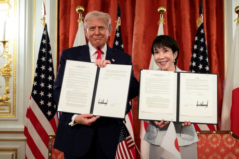 President Donald Trump and Japanese Prime Minister Sanae Takaichi hold up signed documents regarding securing the supply of critical minerals and rare earths, at a bilateral meeting at Akasaka Palace in Tokyo on Tuesday.