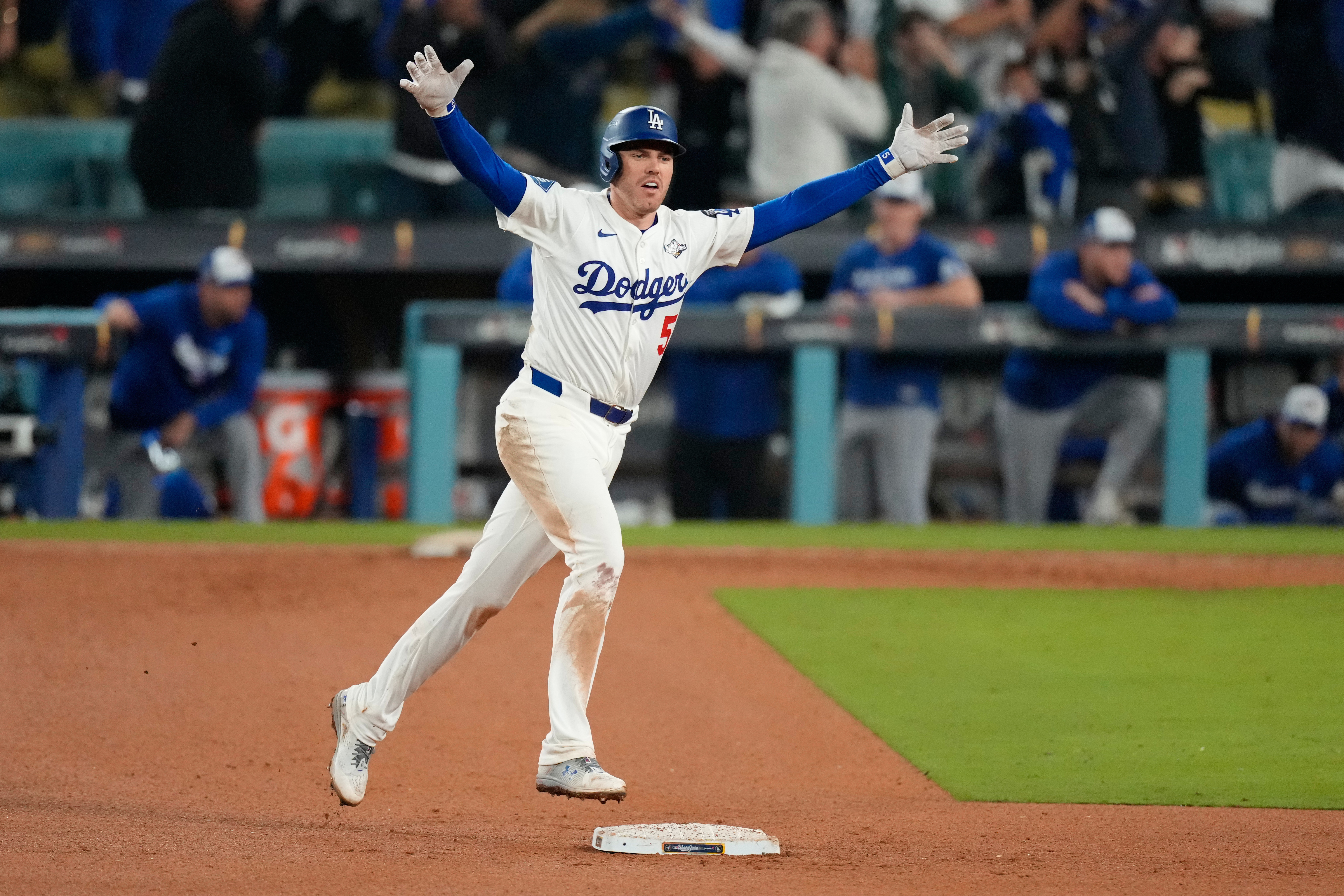 Los Angeles Dodgers' Freddie Freeman celebrates his walk off home run against the Toronto Blue Jays during the 18th inning in Game 3 of baseball's World Series, Monday, Oct. 27, 2025, in Los Angeles. 