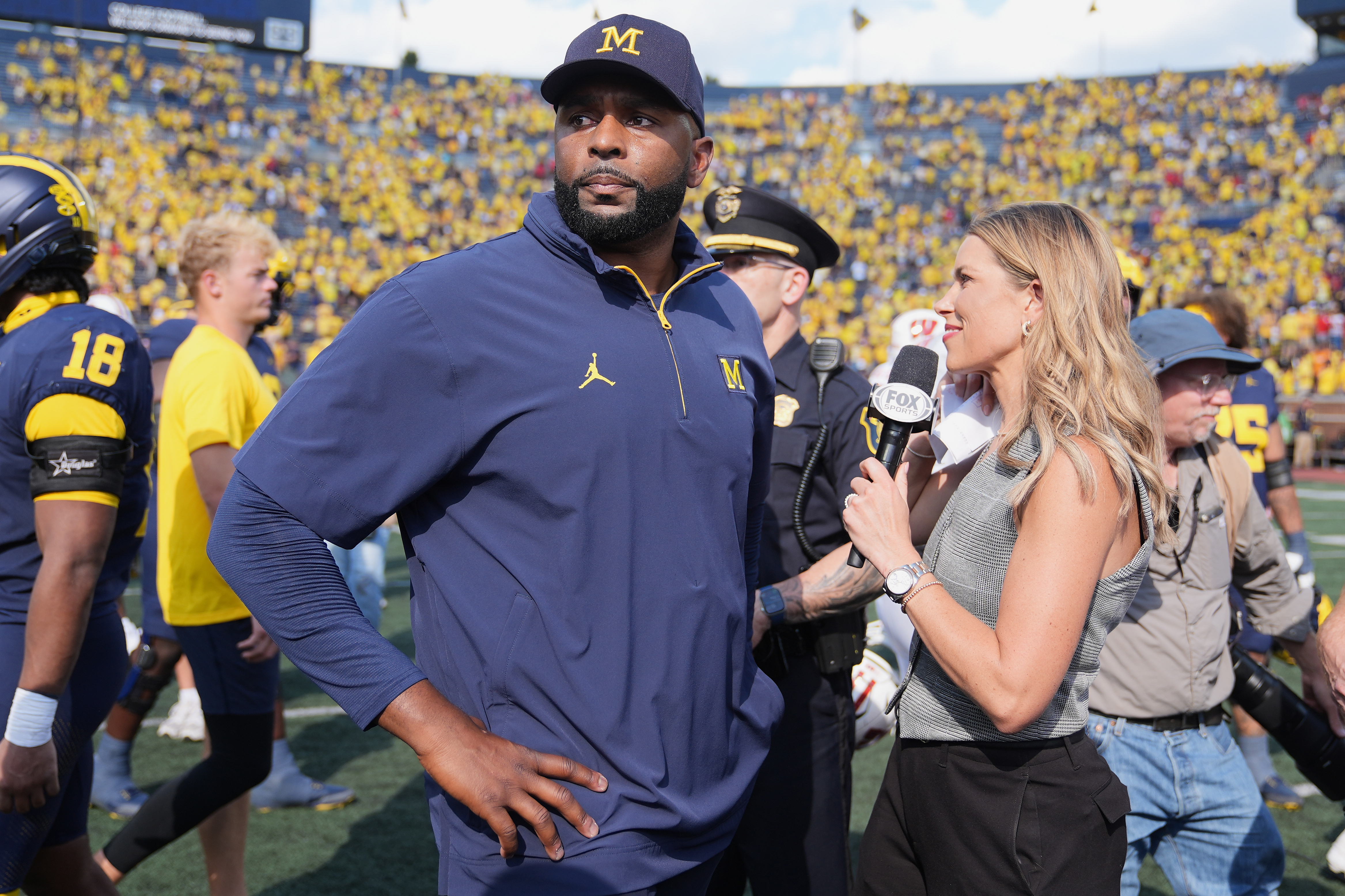 Michigan head coach Sherrone Moore gives a news interview after the team's win in an NCAA college football game against Wisconsin, Saturday, Oct. 4, 2025, in Ann Arbor, Mich. 