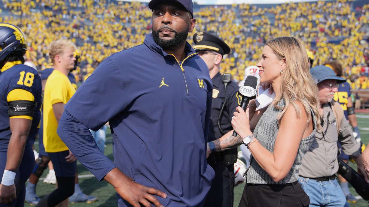 Michigan head coach Sherrone Moore gives a news interview after the team's win in an NCAA college football game against Wisconsin, Saturday, Oct. 4, 2025, in Ann Arbor, Mich.