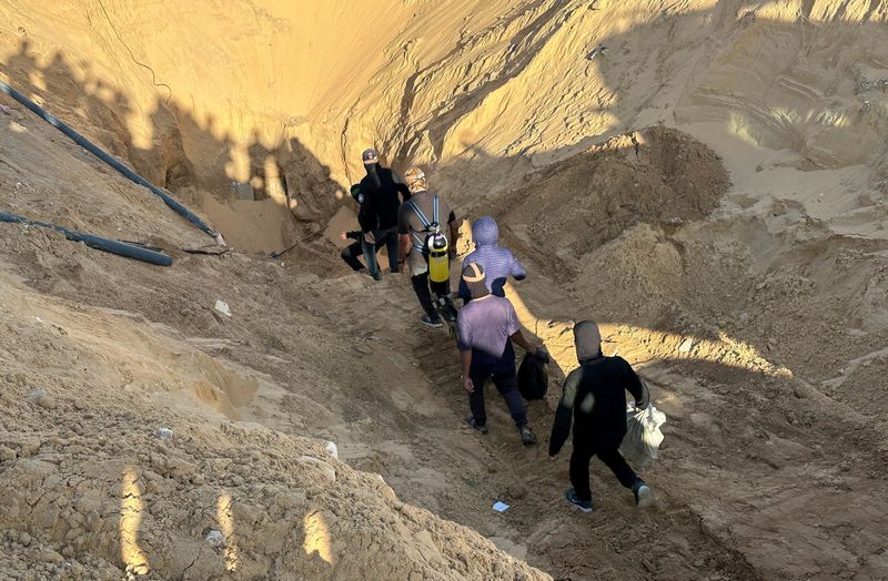 Hamas militants search for the bodies of deceased hostages, kidnapped by Hamas during the Oct. 7, 2023, attack on Israel, amid a ceasefire between Israel and Hamas, in Khan Younis, southern Gaza Strip, Tuesday.