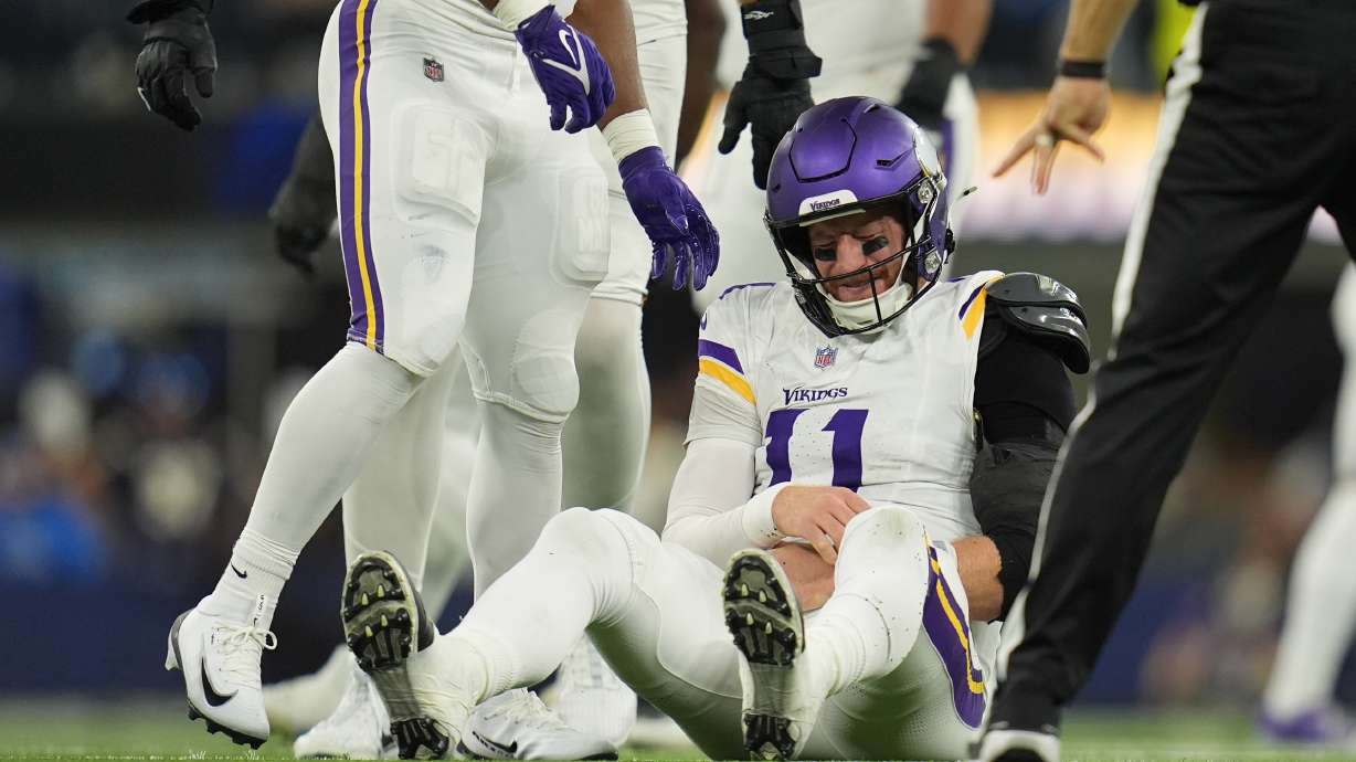 Minnesota Vikings quarterback Carson Wentz (11) sits on the ground after a hit during the second half of an NFL football game against the Los Angeles Chargers Thursday, Oct. 23, 2025, in Inglewood, Calif.