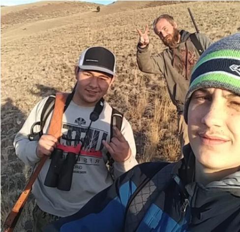 Chase Ellett, front right, Tristan Hatch, left, and one of their brothers walk outdoors.