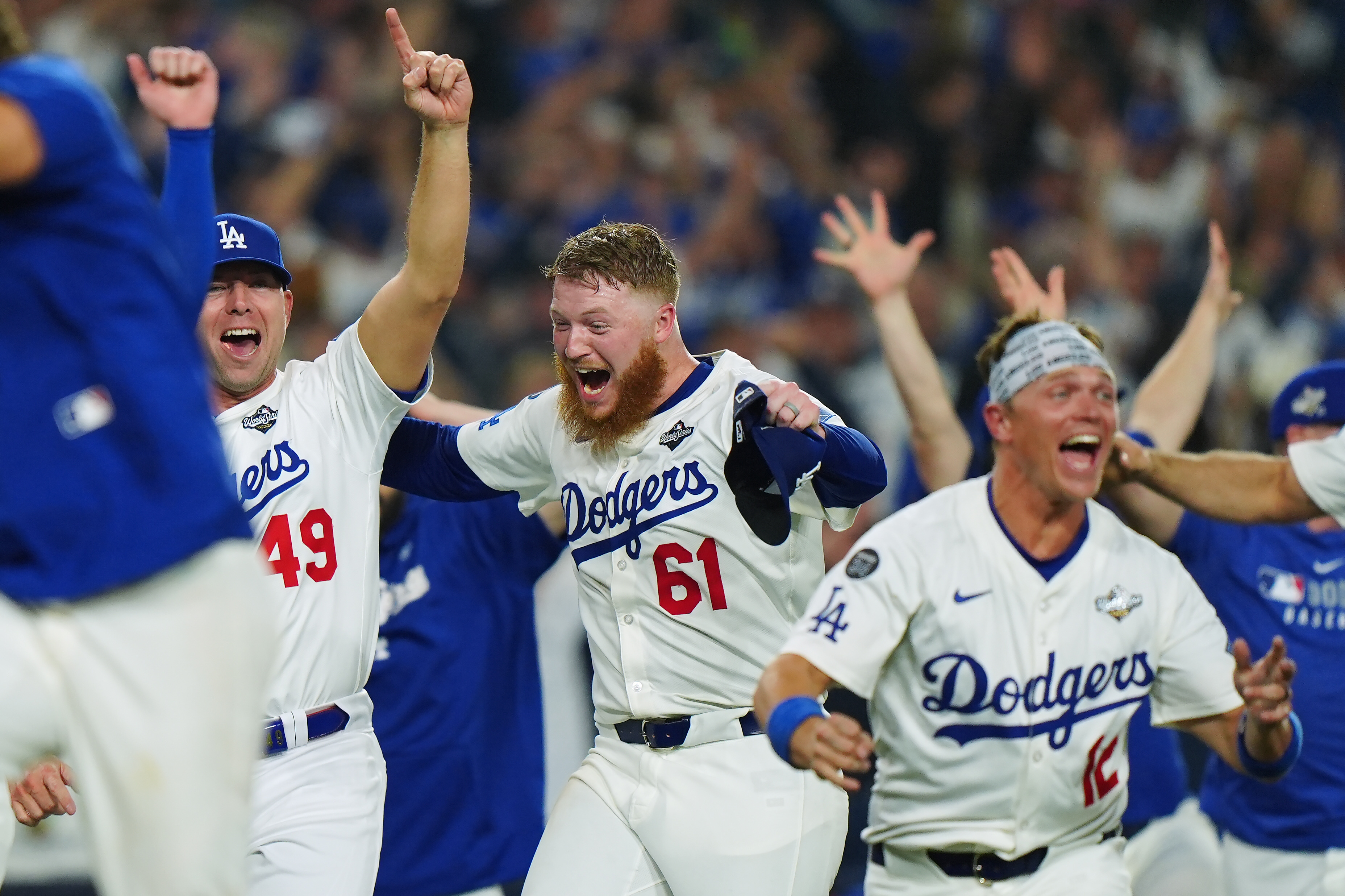 Winning Los Angeles Dodgers pitcher Will Klein (61) celebrates with Blake Treinen (49) and Alex Call (12) during 18th inning Game 3 World Series playoff MLB baseball action in Los Angeles on Monday, Oct. 27, 2025. 