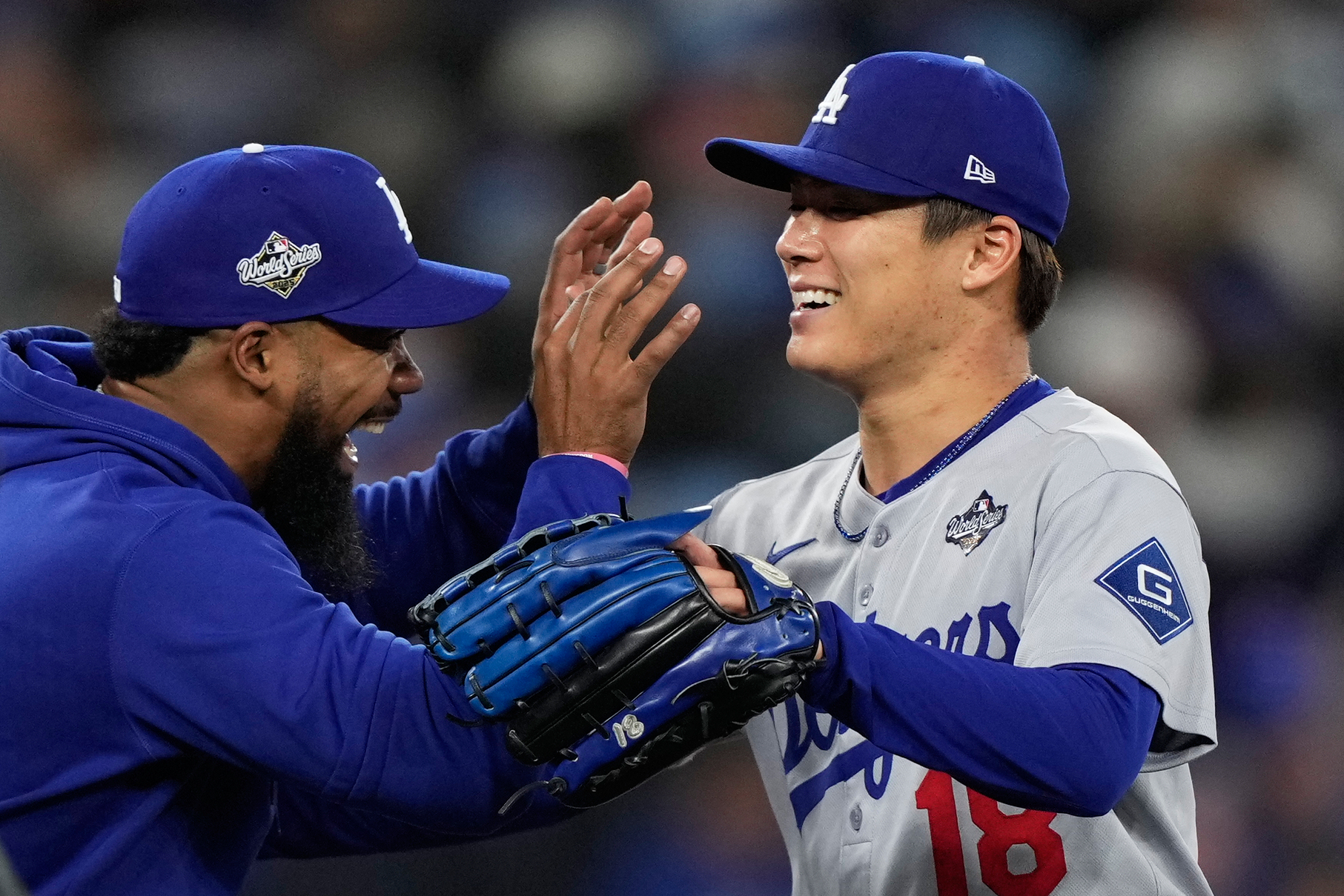 Los Angeles Dodgers pitcher Yoshinobu Yamamoto celebrates with right fielder Teoscar Hernández after throwing compete game against the Toronto Blue Jays in Game 2 of baseball's World Series, Saturday, Oct. 25, 2025, in Toronto. 